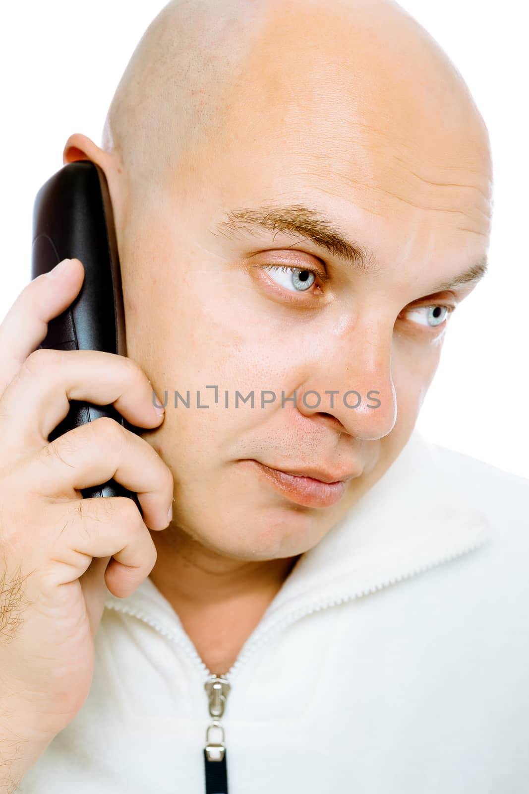 Bald, blue-eyed man in a white jacket with a telephone. Studio. isolated