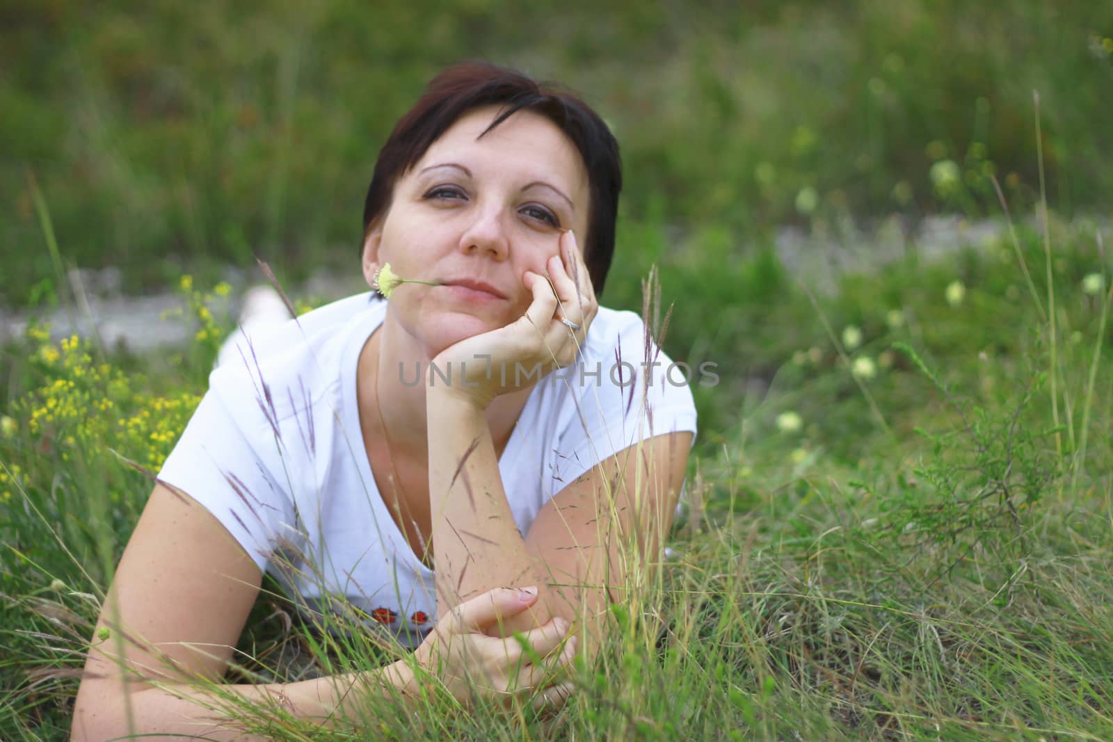 Woman laying in the grass on the meadow