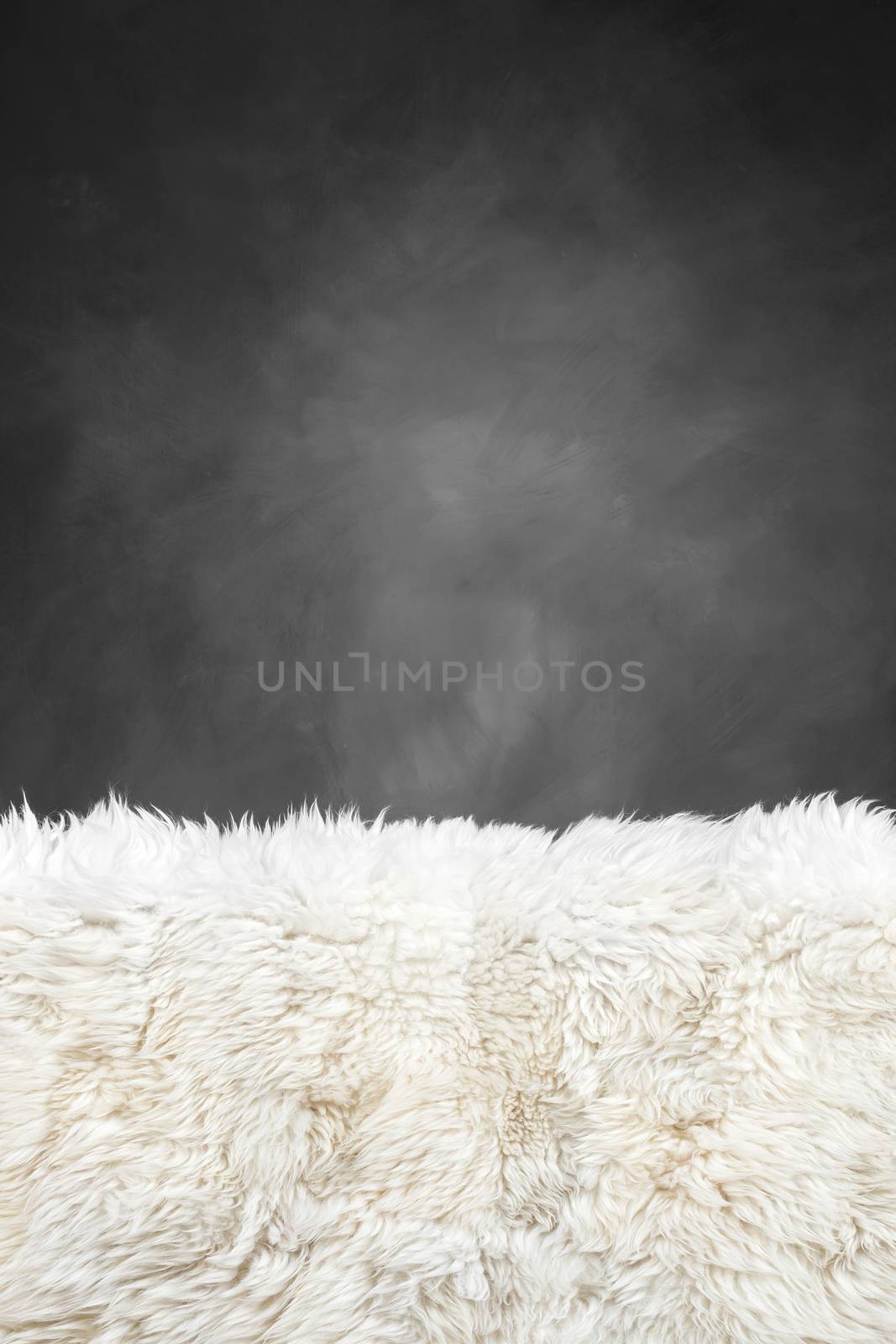 white fur carpet and dark grey painted wall , use for background
