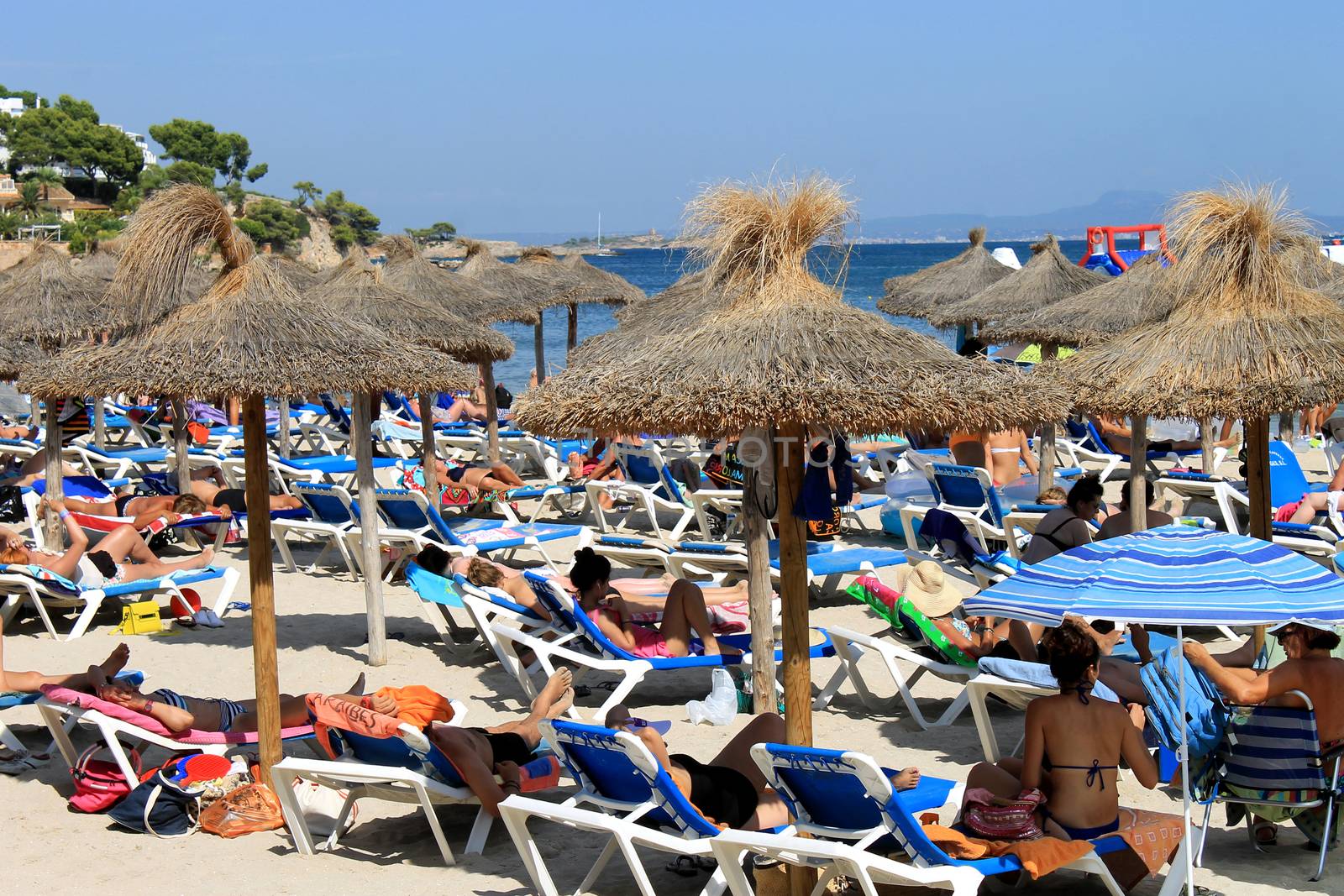 Sunbathers on a Spanish beach in summer by speedfighter