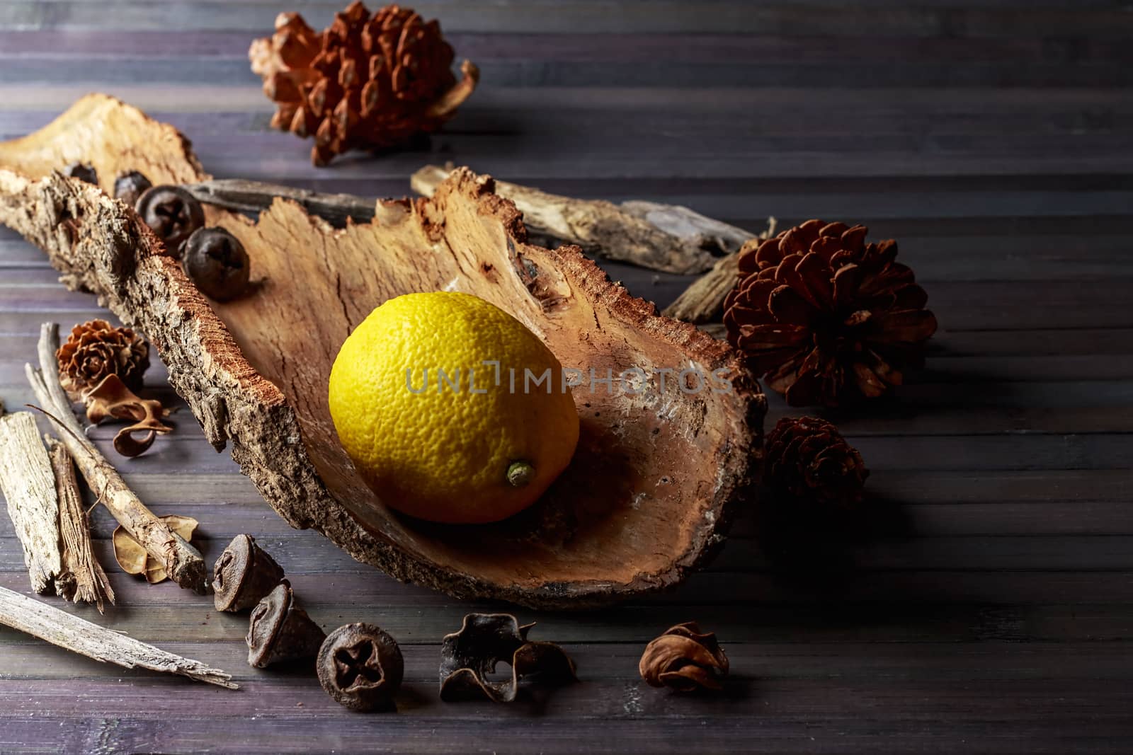 Lemon with rustic decor in a wooden table. Horizontal image.