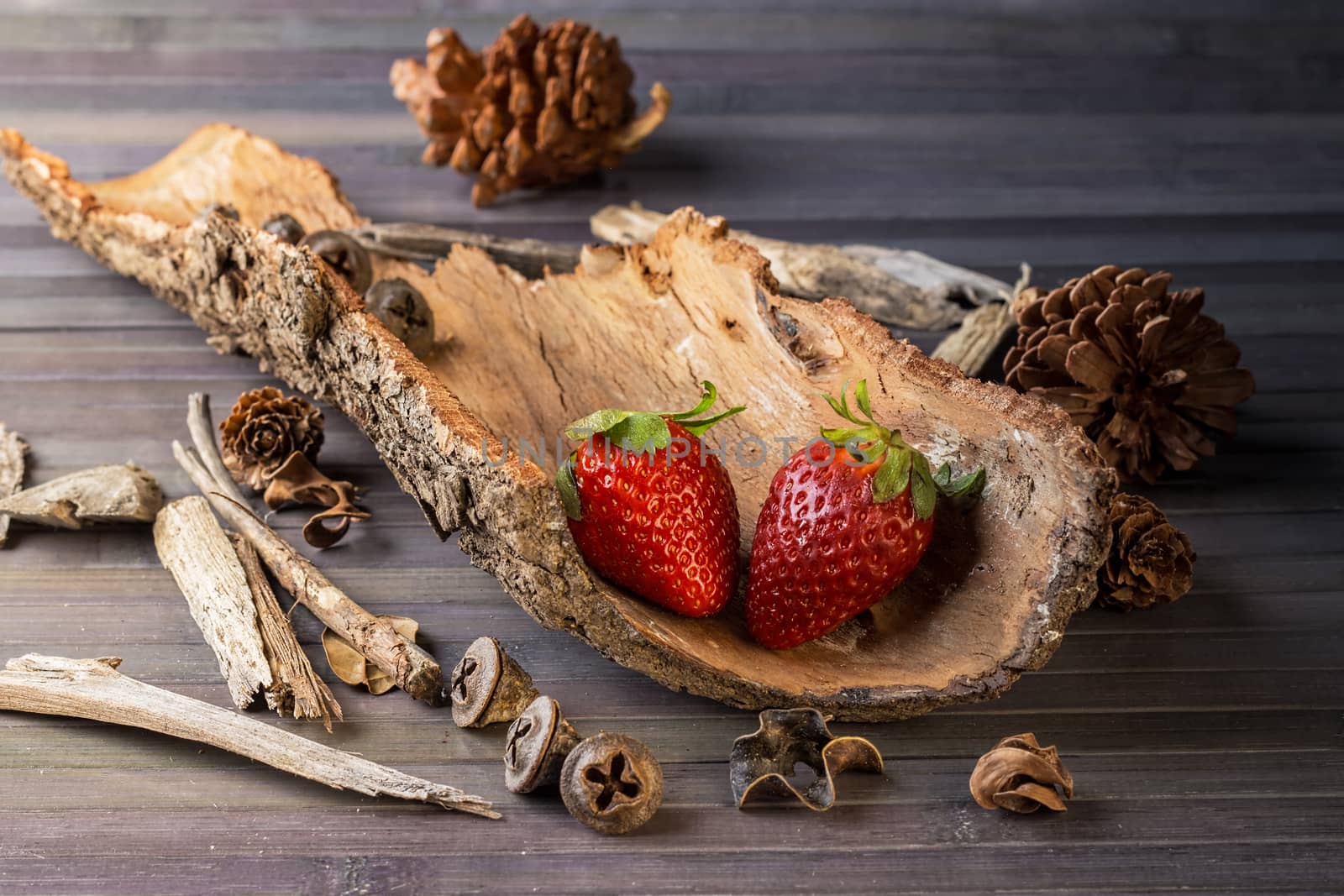 Strawberries with rustic decor in a wooden table. Horizontal image.