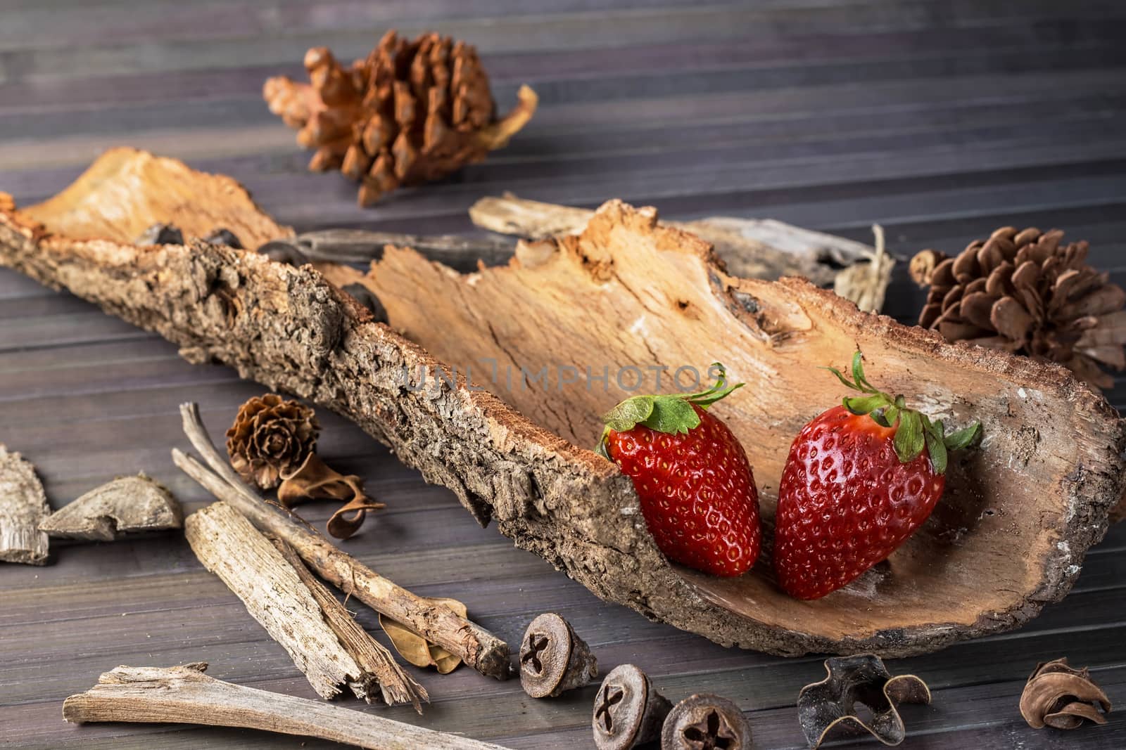 Strawberries with rustic decor in a wooden table. Horizontal image.