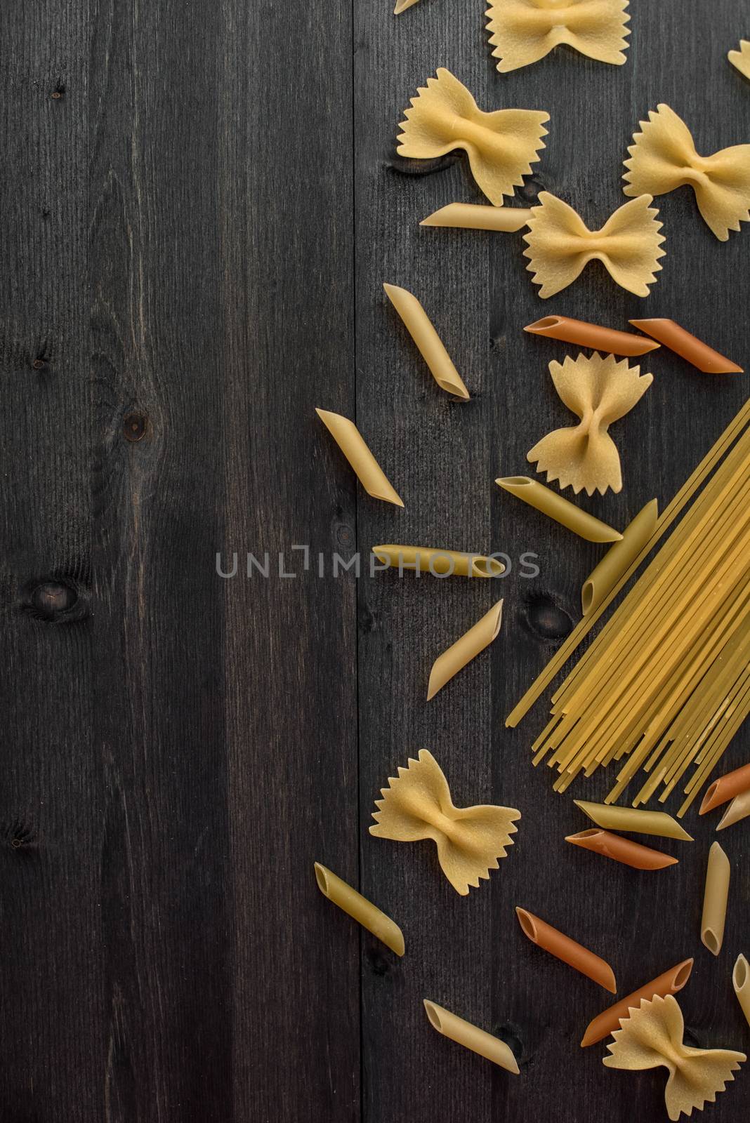 Pasta collection on rustic dark wooden background
