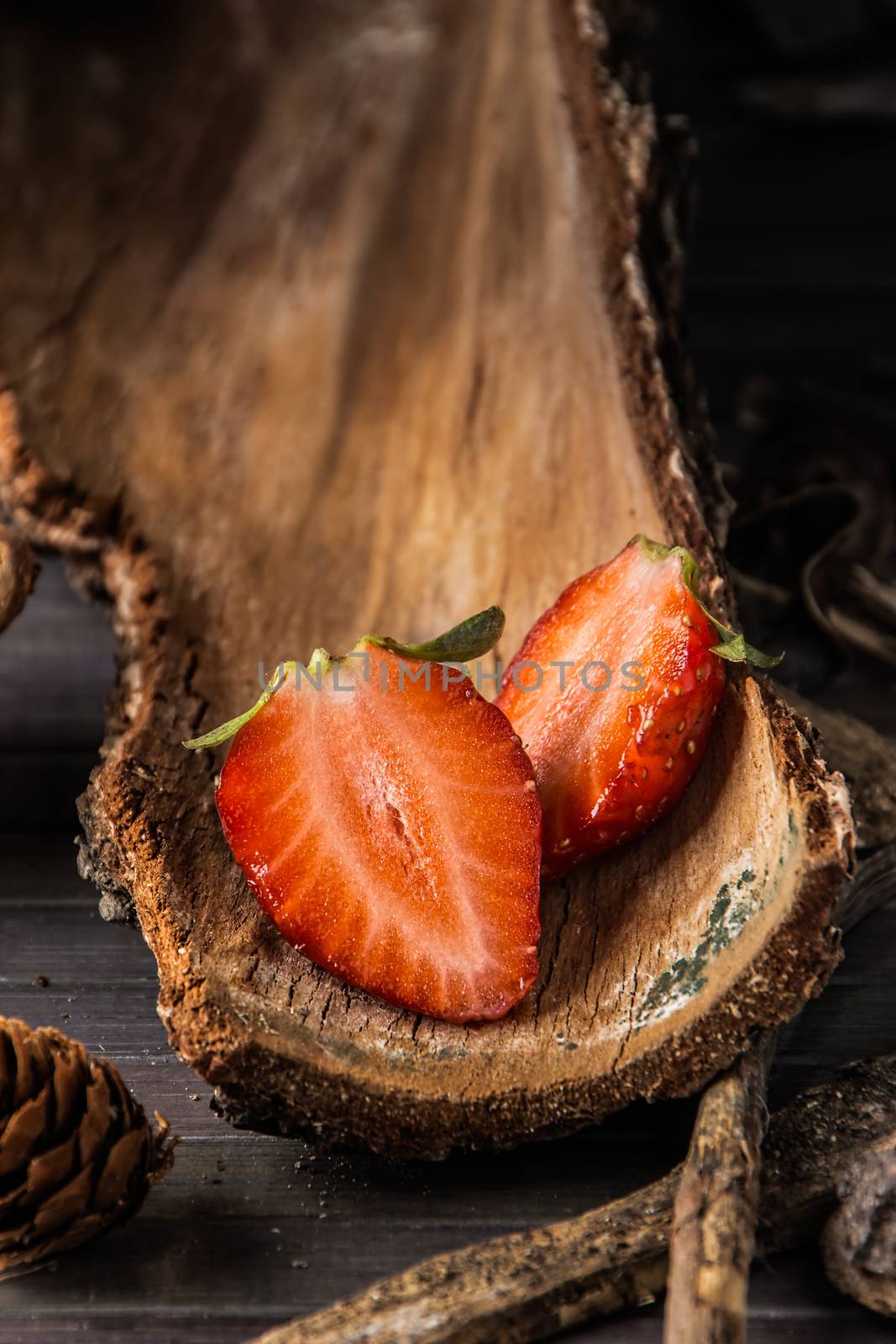 Strawberries with rustic decor in a wooden table. Vertical image.
