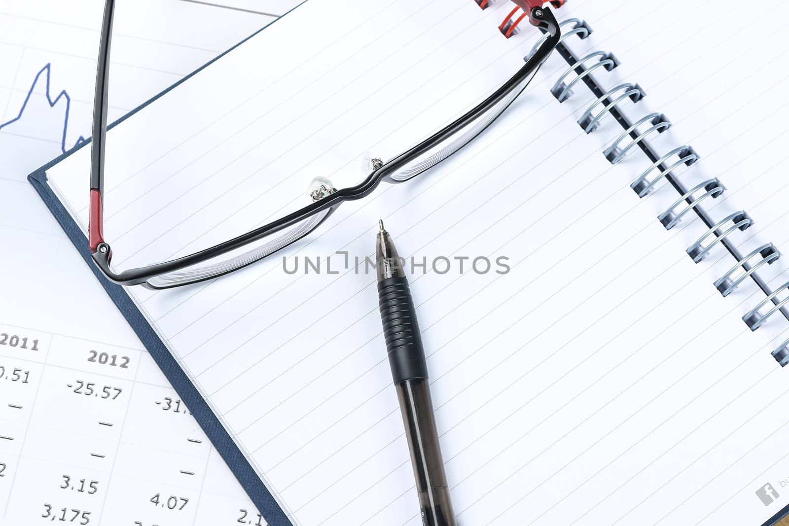 pen, notebook, glasses and financial report  by simpleBE