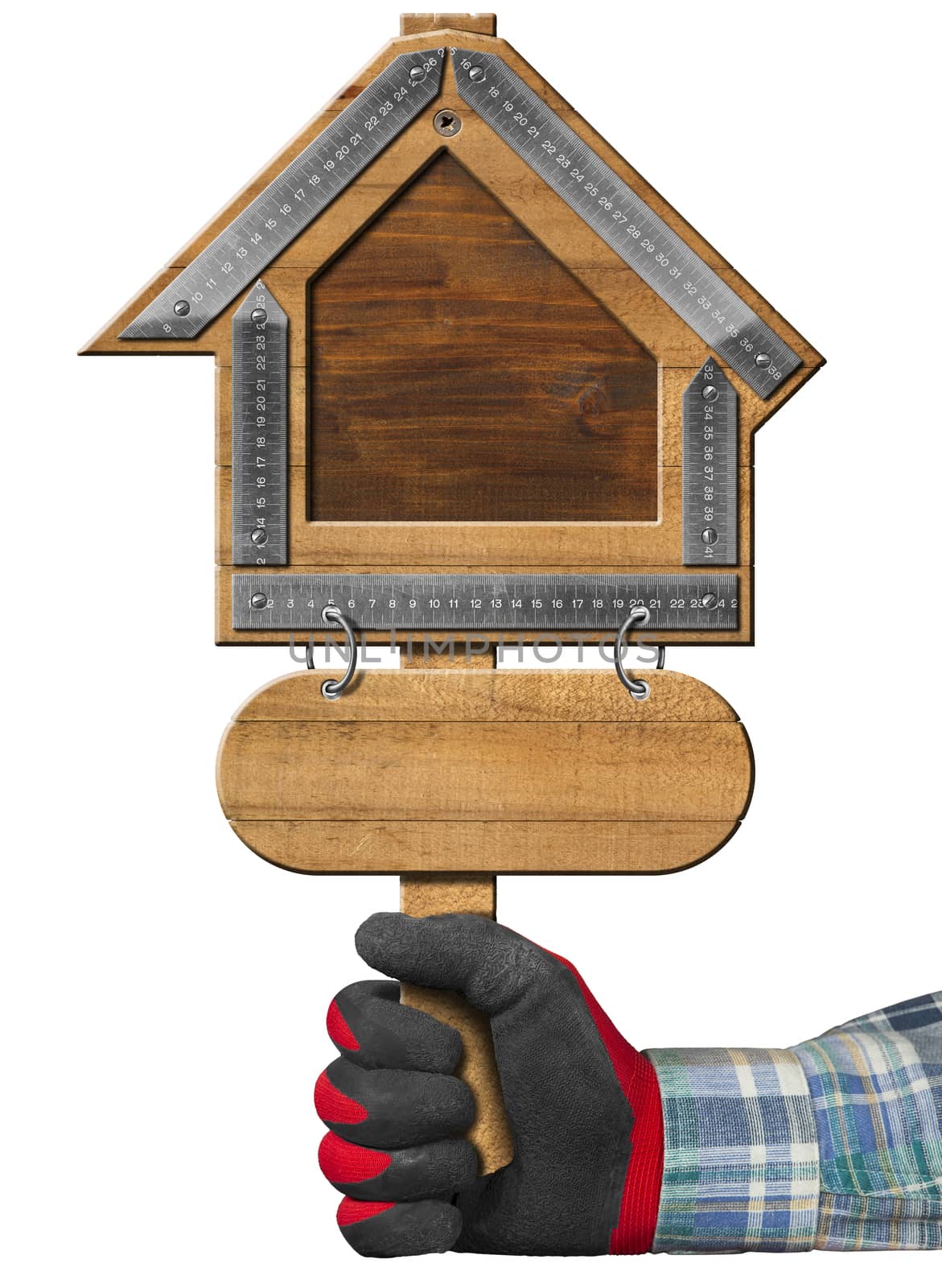 Hand with work glove holding a wooden sign with a meter ruler in the shape of house. Empty sign for the construction industry, isolated on white