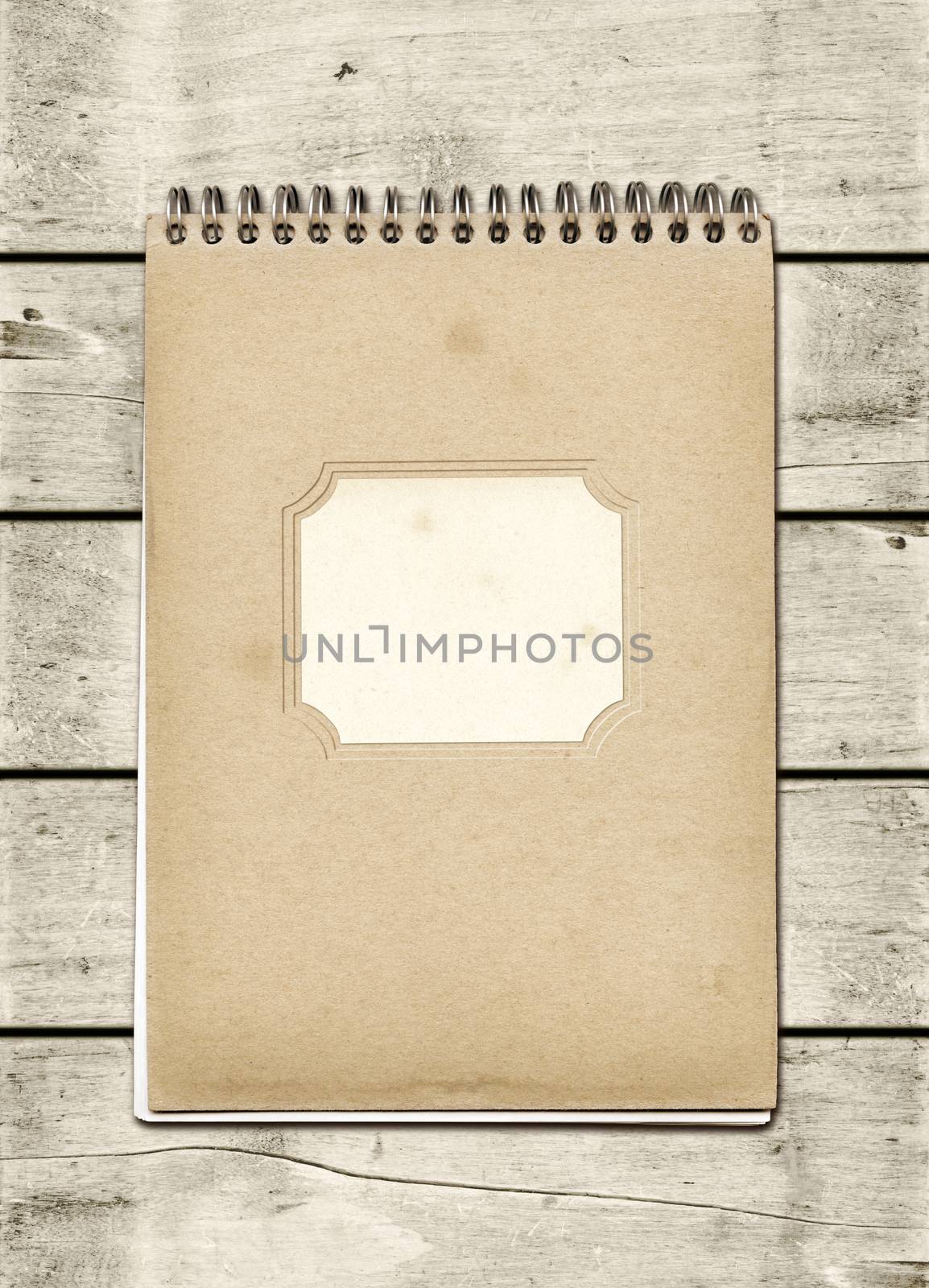 Closed spiral Note book on a white wood table. Mockup