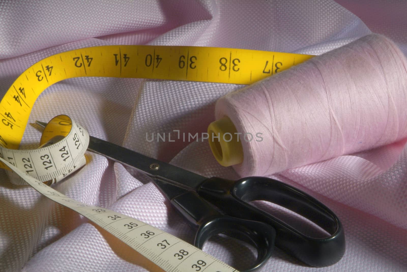 tailor tools on pink fabric by diecidodici