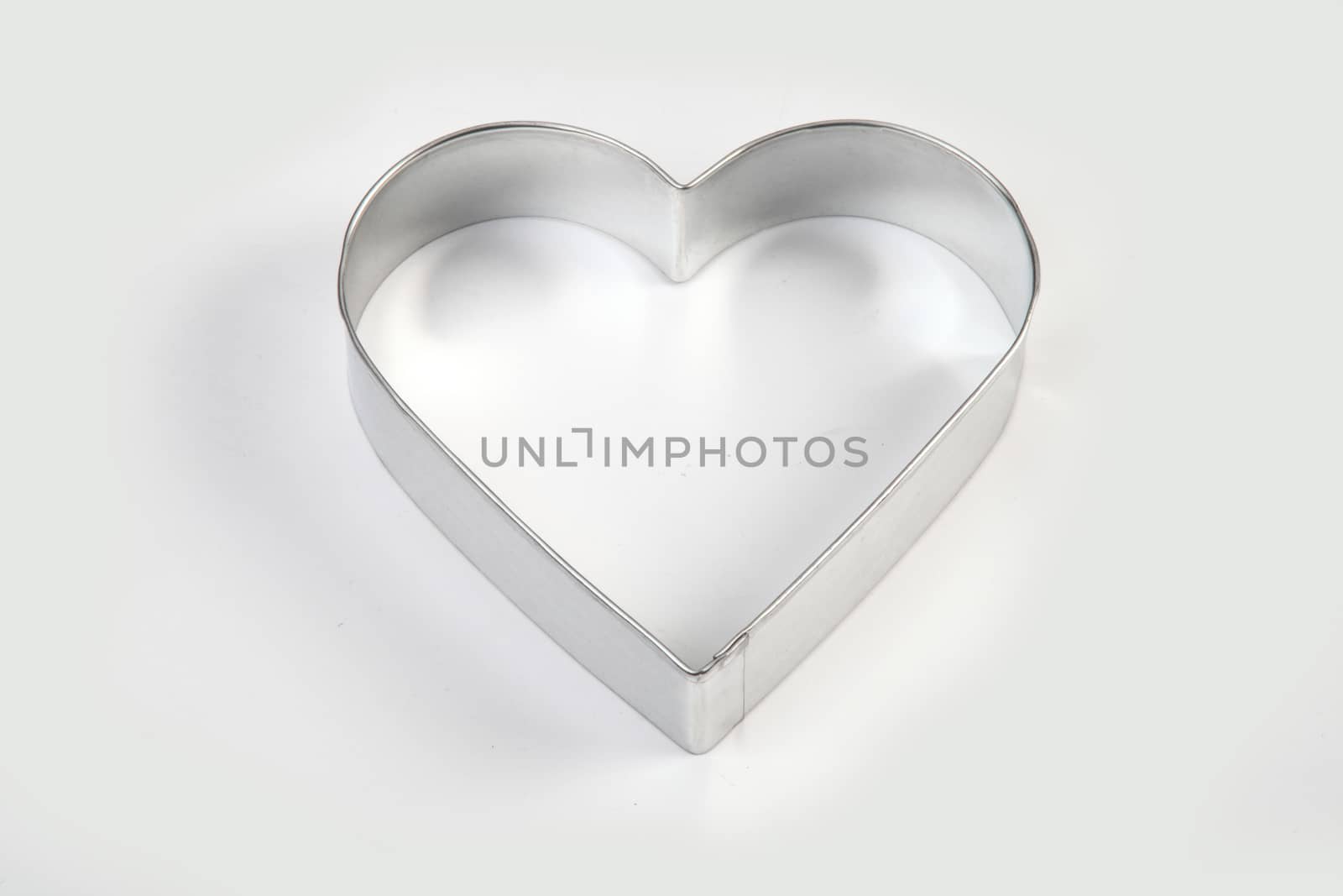 steel mold heart - shaped on white background