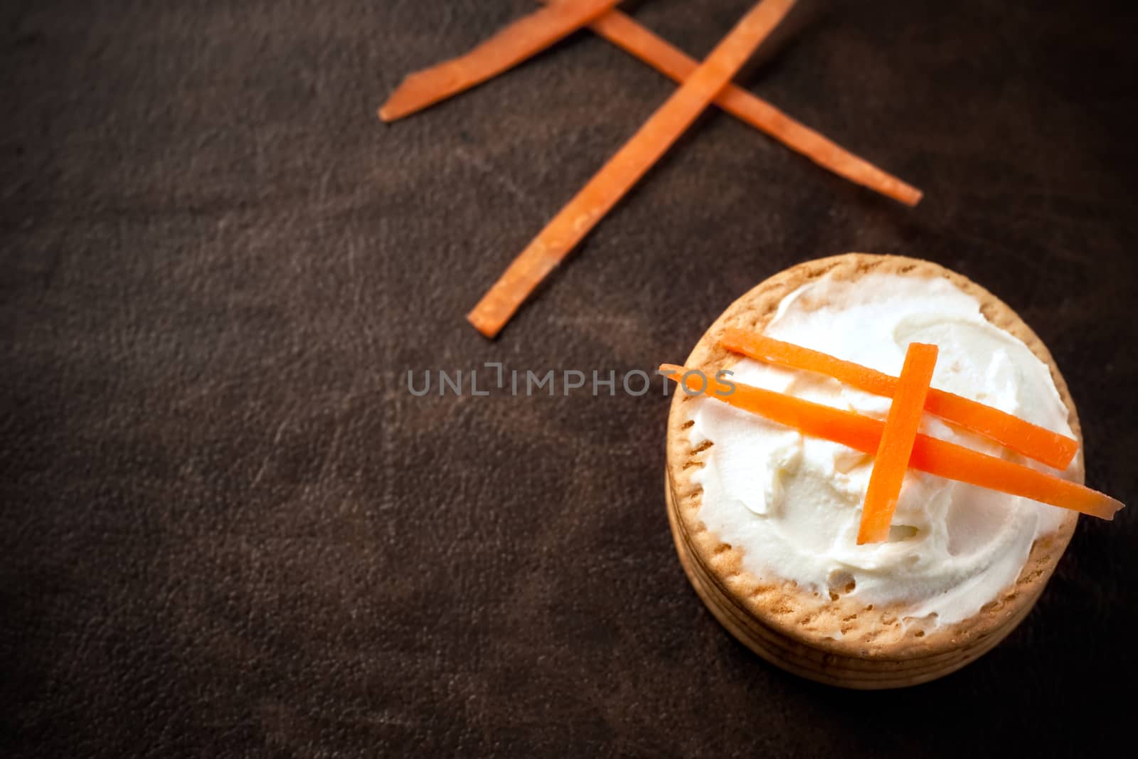 Cookies with cream cheese and strips of carrot