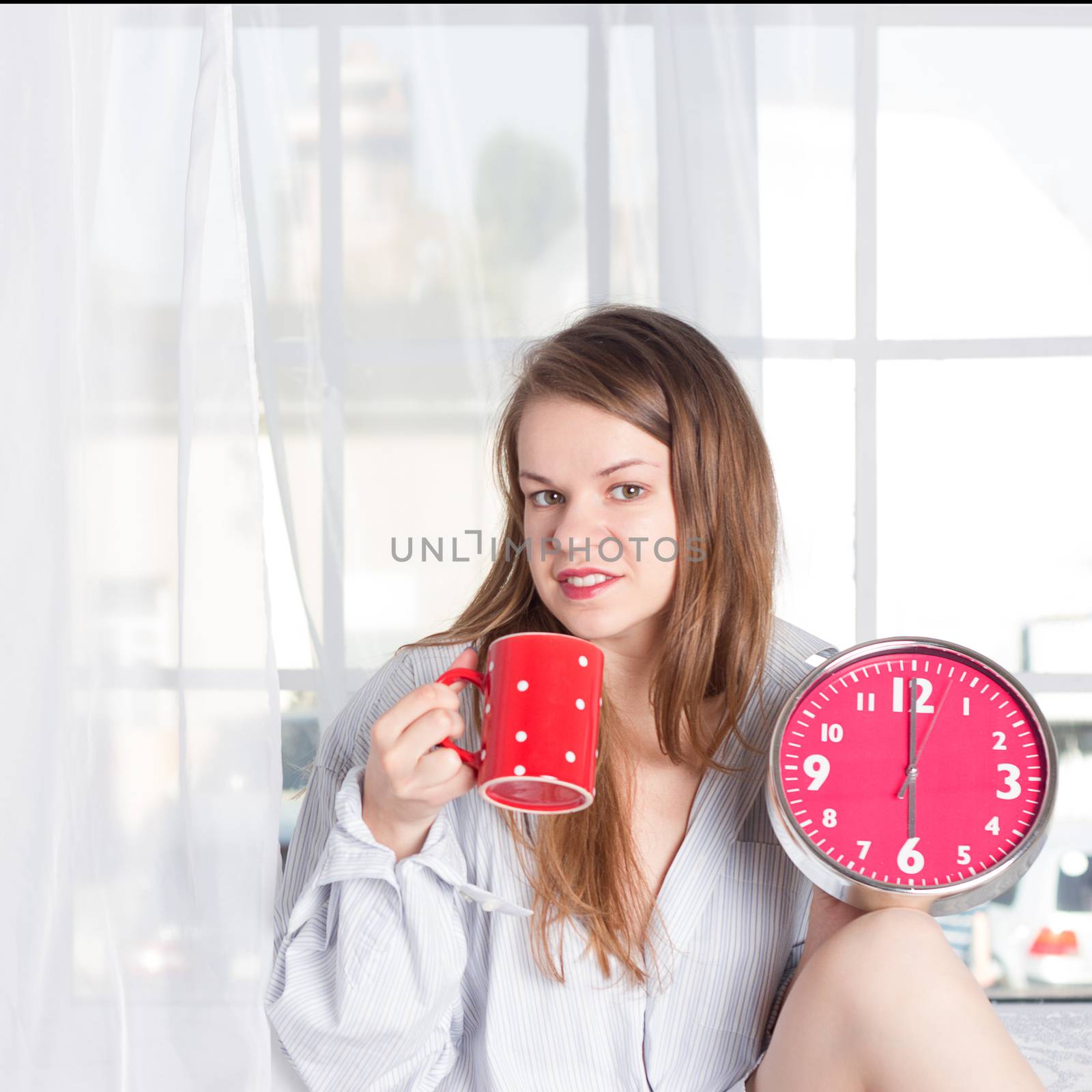 Happy girl  wake up with alarm clock and  coffee cup 6 a.m by victosha