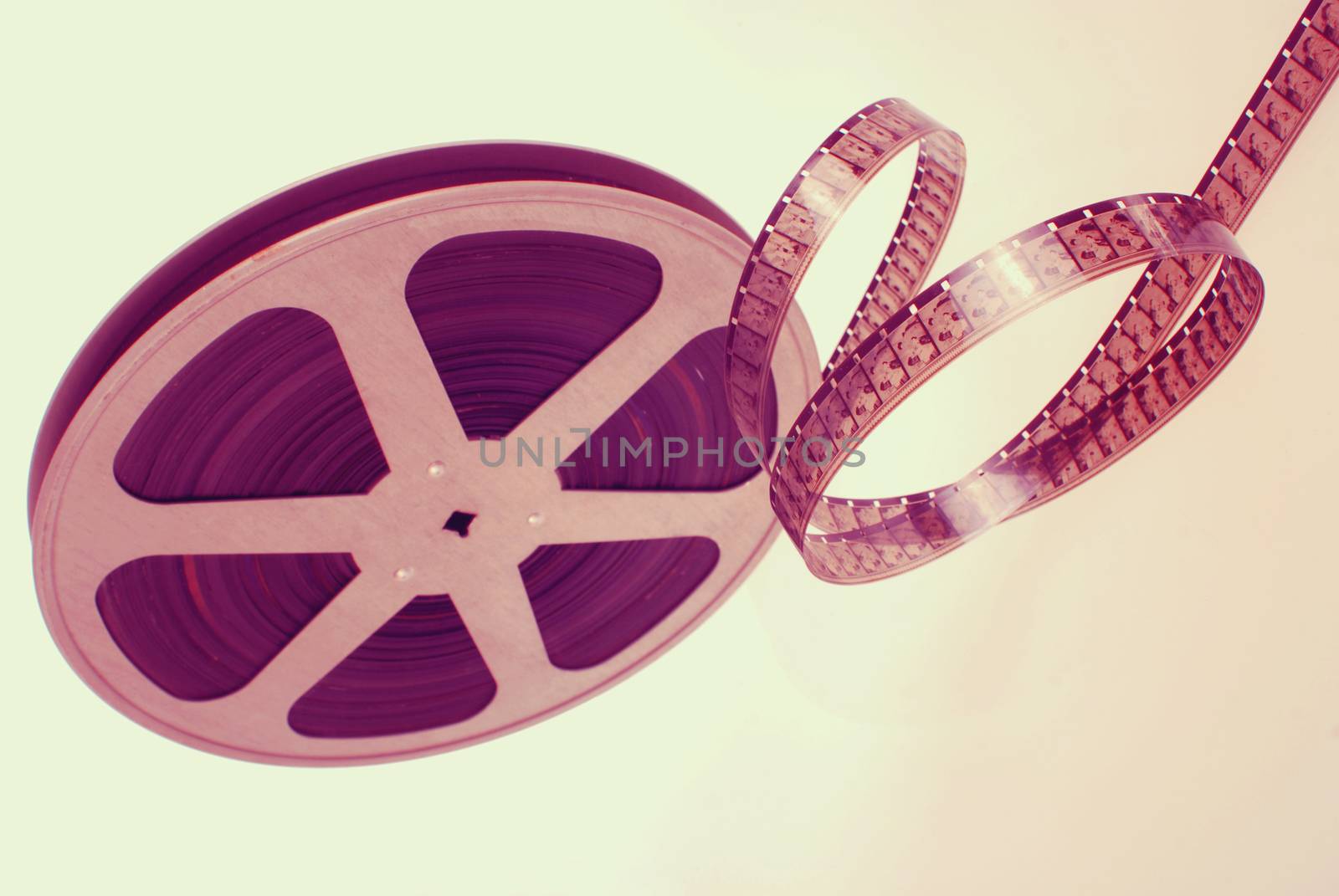 Vintage analogic photographic film strip wheel isolated on white background.