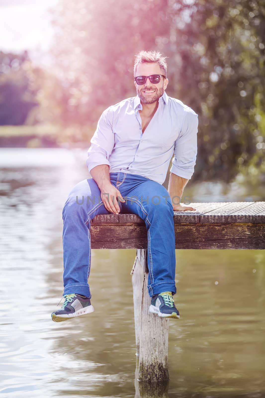 An image of a bearded man at the lake