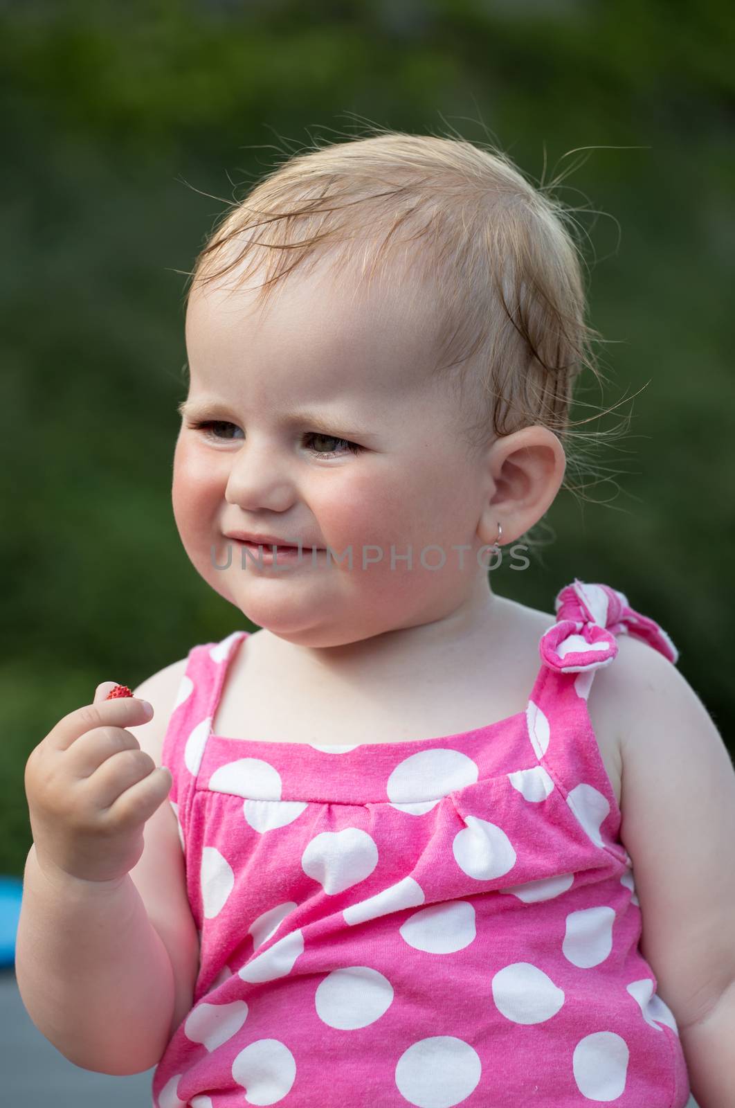 Happy cute little one year old girl outdoor, summer, with pink dress