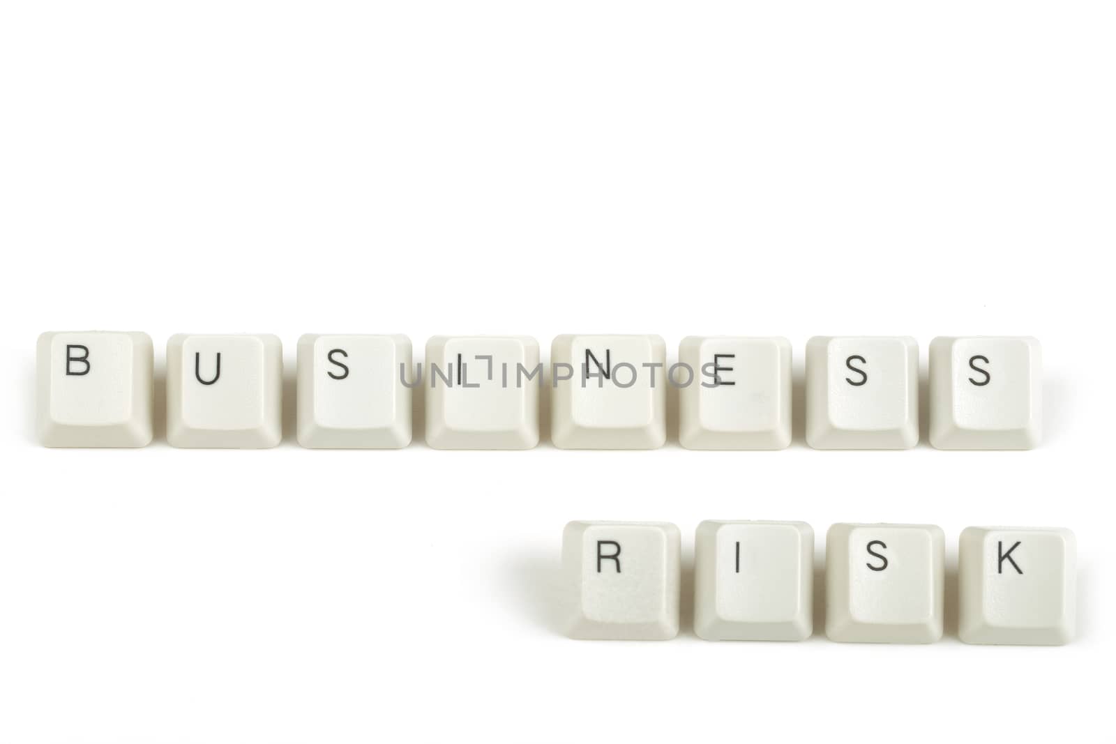 business risk  text from scattered keyboard keys isolated on white background