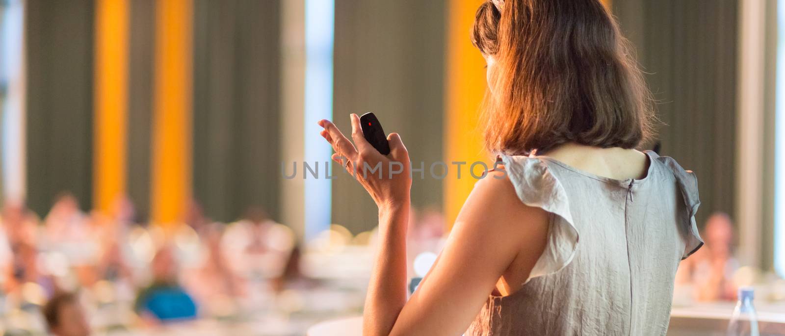 Female speaker at Business Conference and Presentation. Audience at the conference hall. Business and Entrepreneurship. Business woman. Horizontal composition.