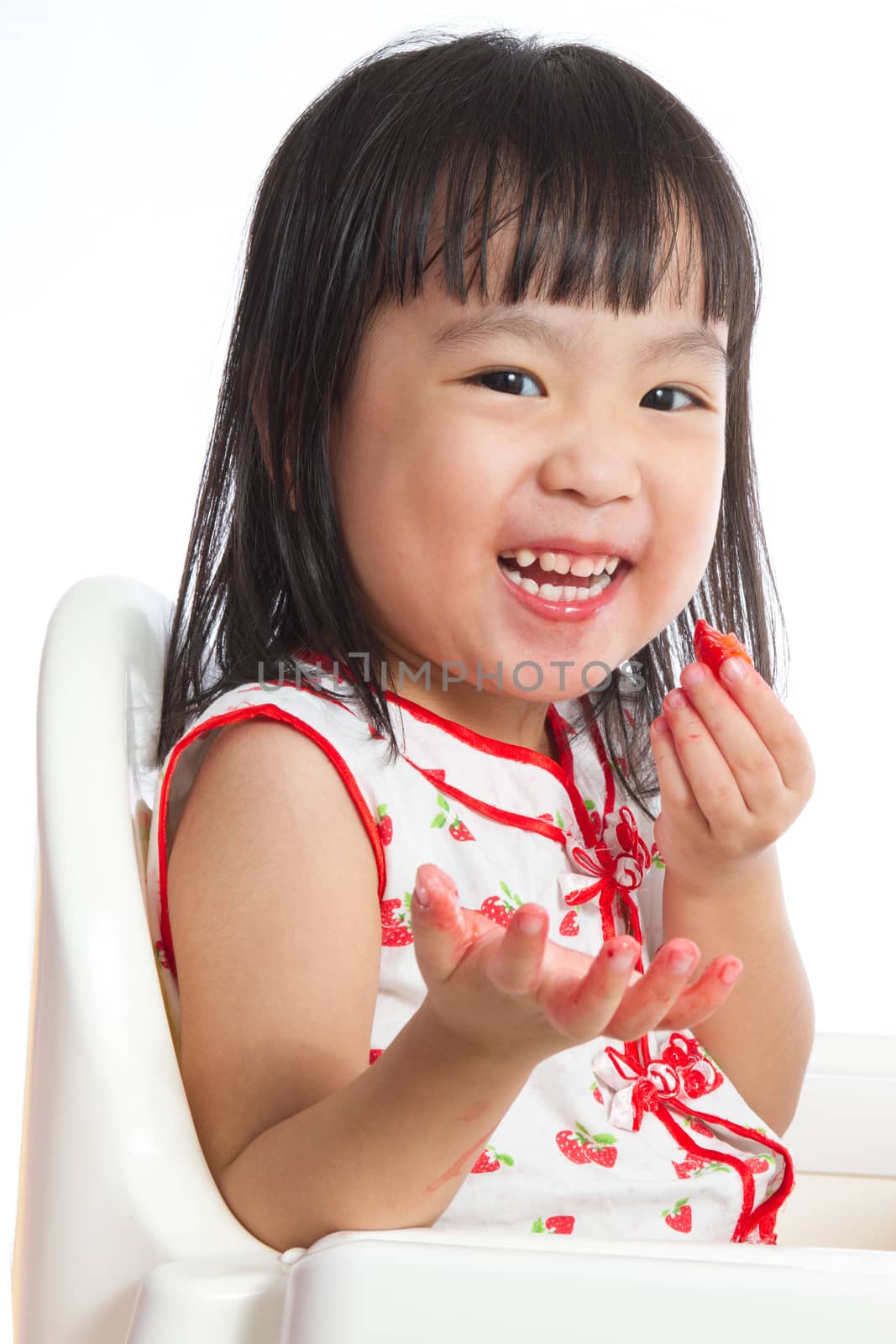 Asian Chinese little girl eating strawberries by kiankhoon