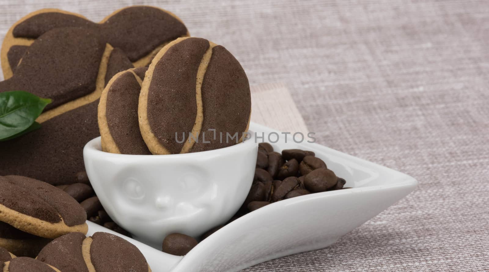 Delicious coffee cookies and coffee beans in a cute cup with facial expressions