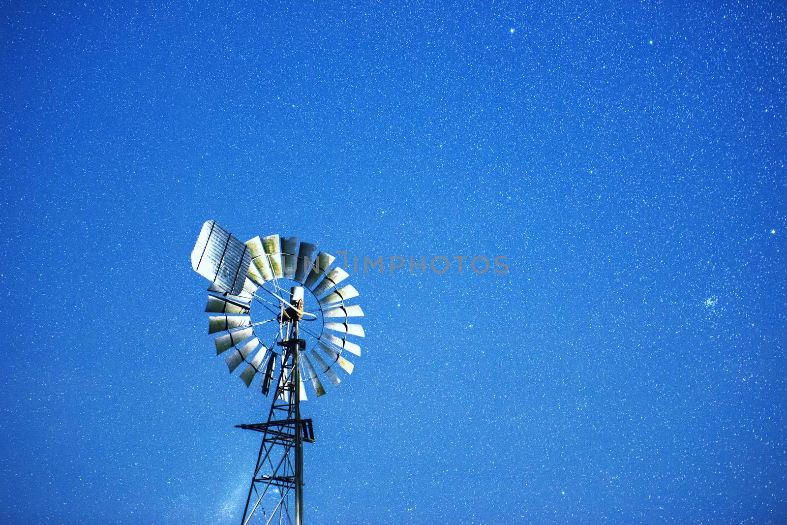 Stars and a windmill at night in the outback of Brisbane, Queensland, Australia.