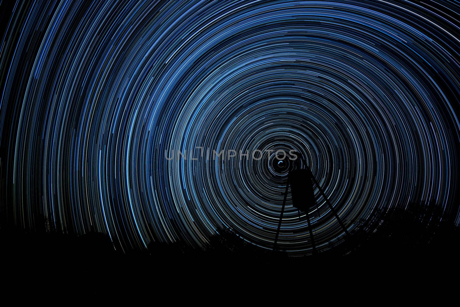 Long exposure of stars creating star trails (Stacked photos)