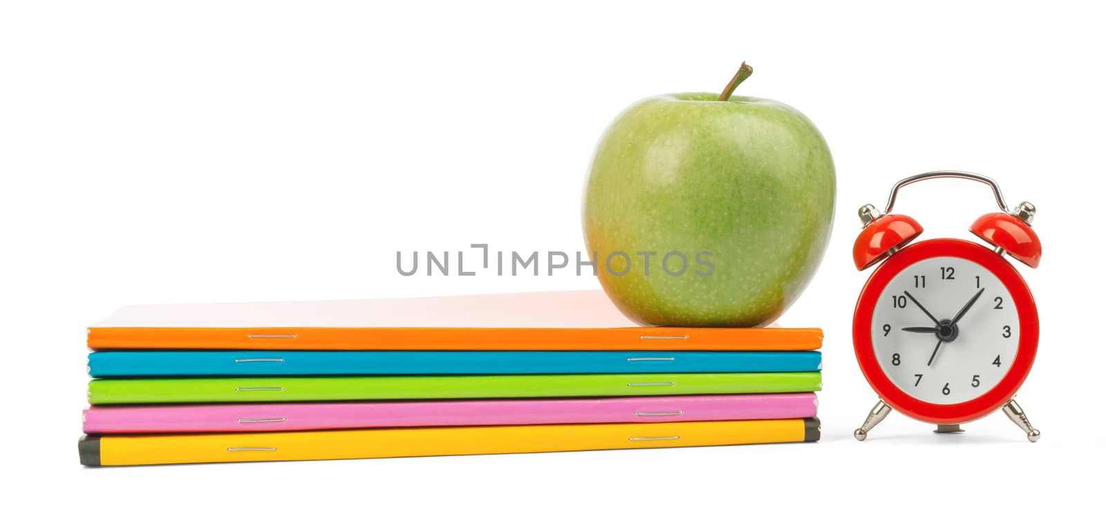 Fresh apple with notebooks and alarm clock by cherezoff