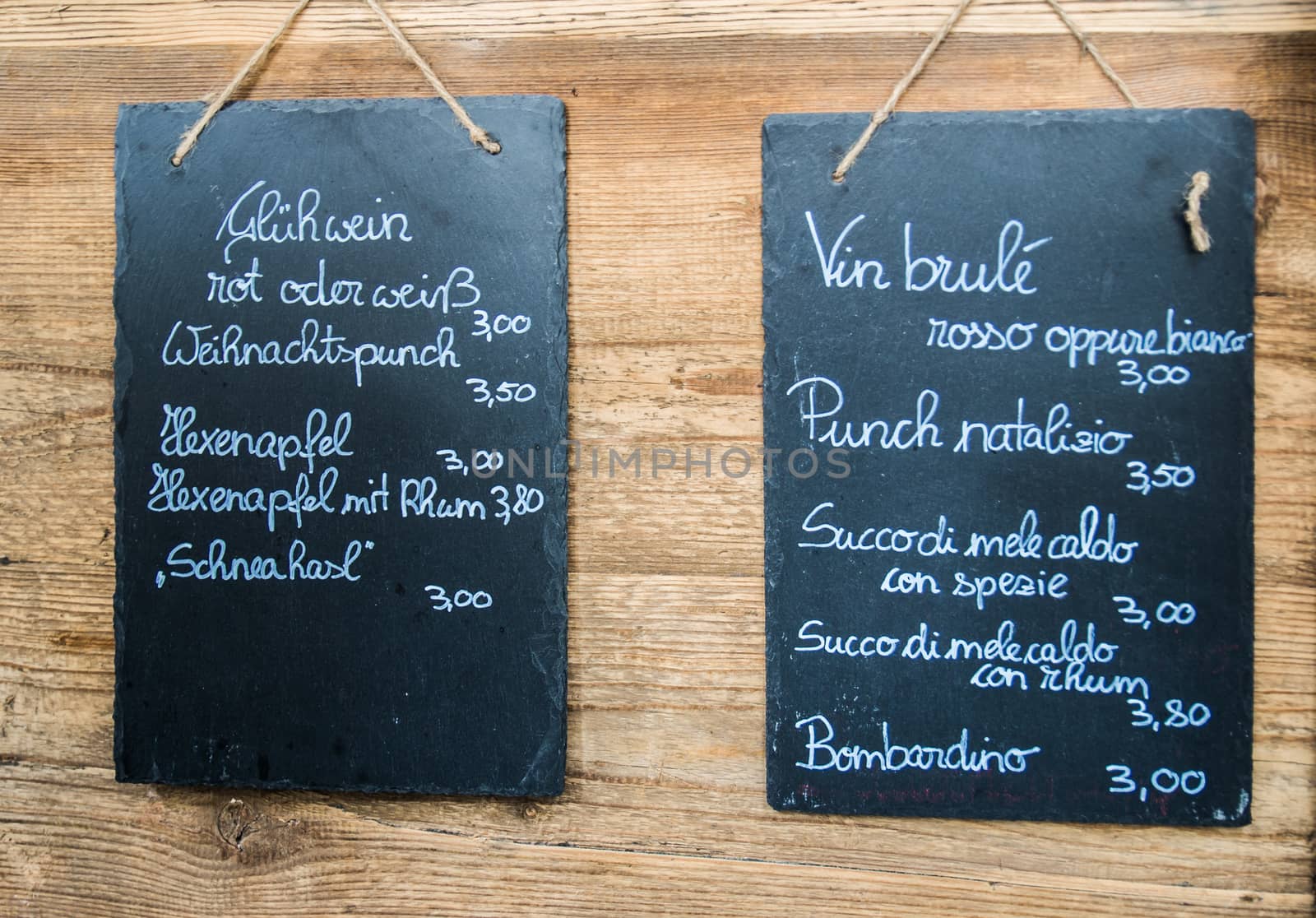 blackboards hanging on the wooden wall with a drink list