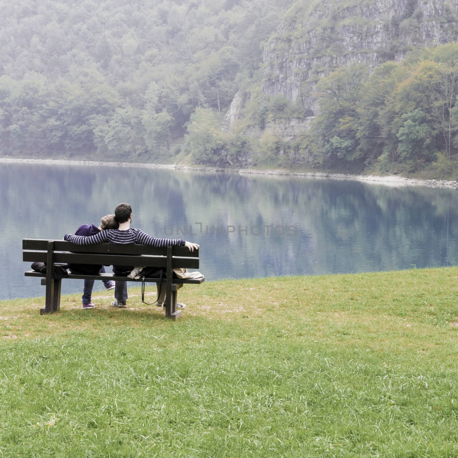 lovers on the bench in front of the lake