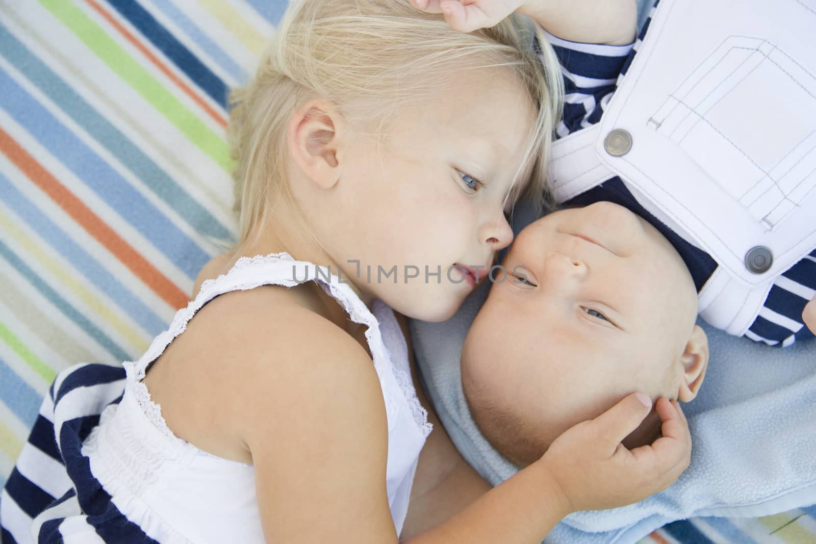 Little Sister Laying Next to Her Baby Brother on Blanket by Feverpitched