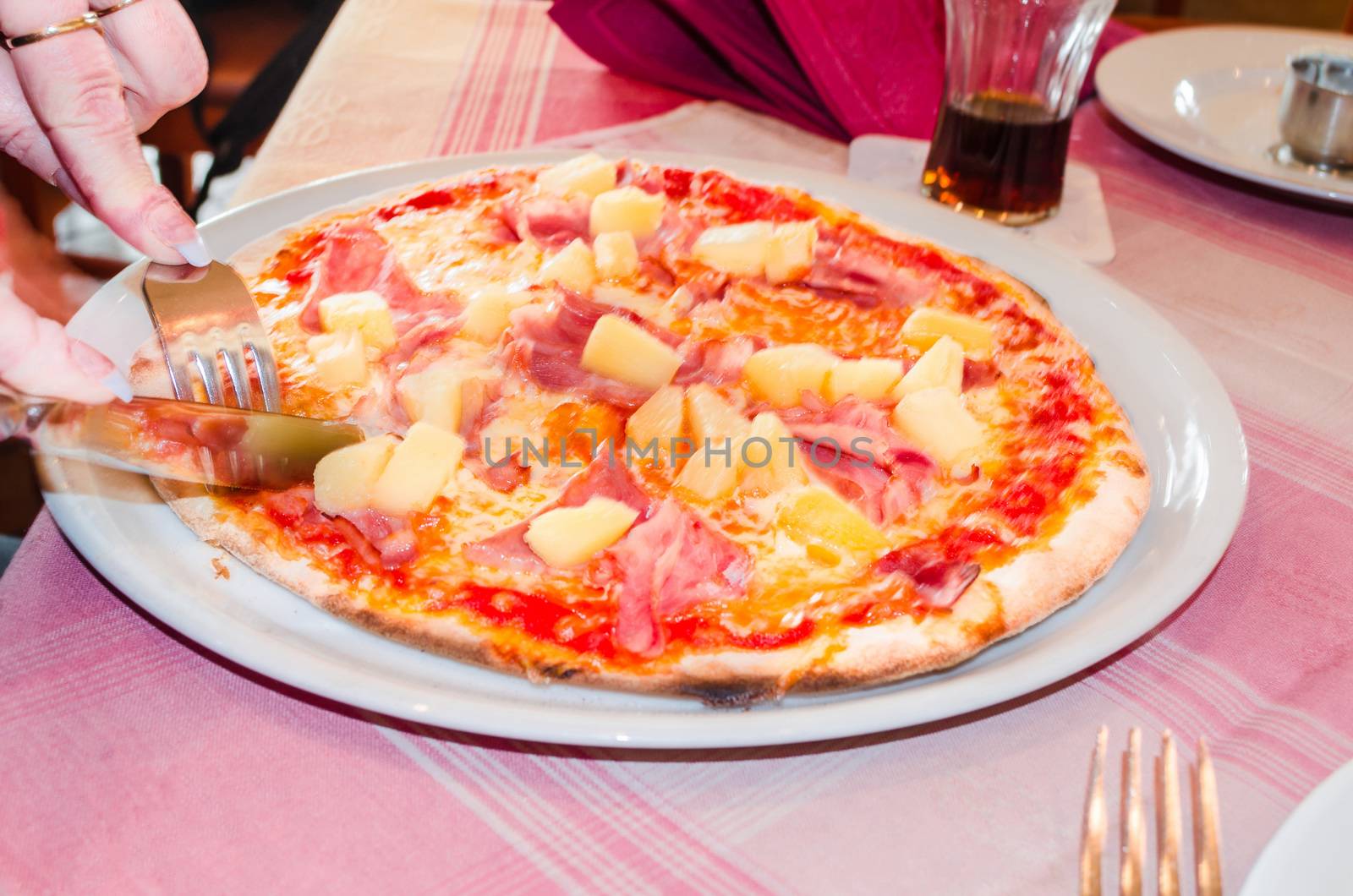Delicious spicy Pizza Hawai in a pizzeria.