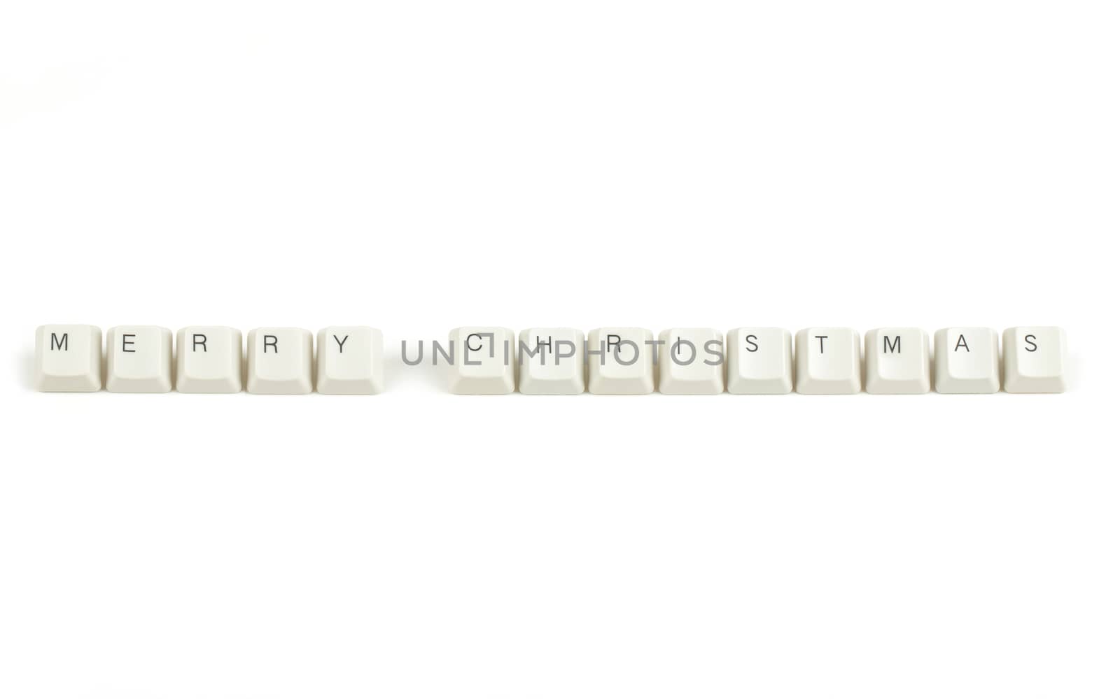 merry christmas text from scattered keyboard keys isolated on white background