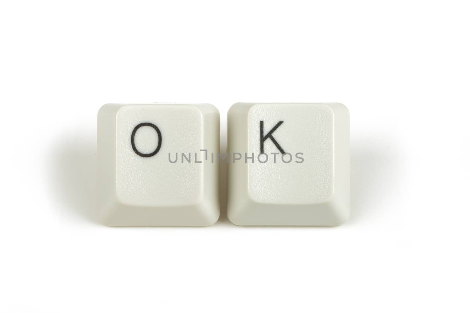 ok text from scattered keyboard keys isolated on white background