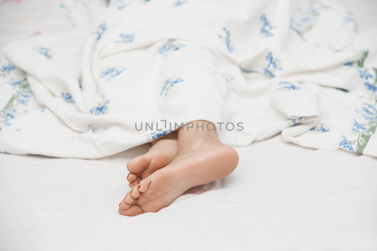 Feet of sleeping woman. Horizontal photo