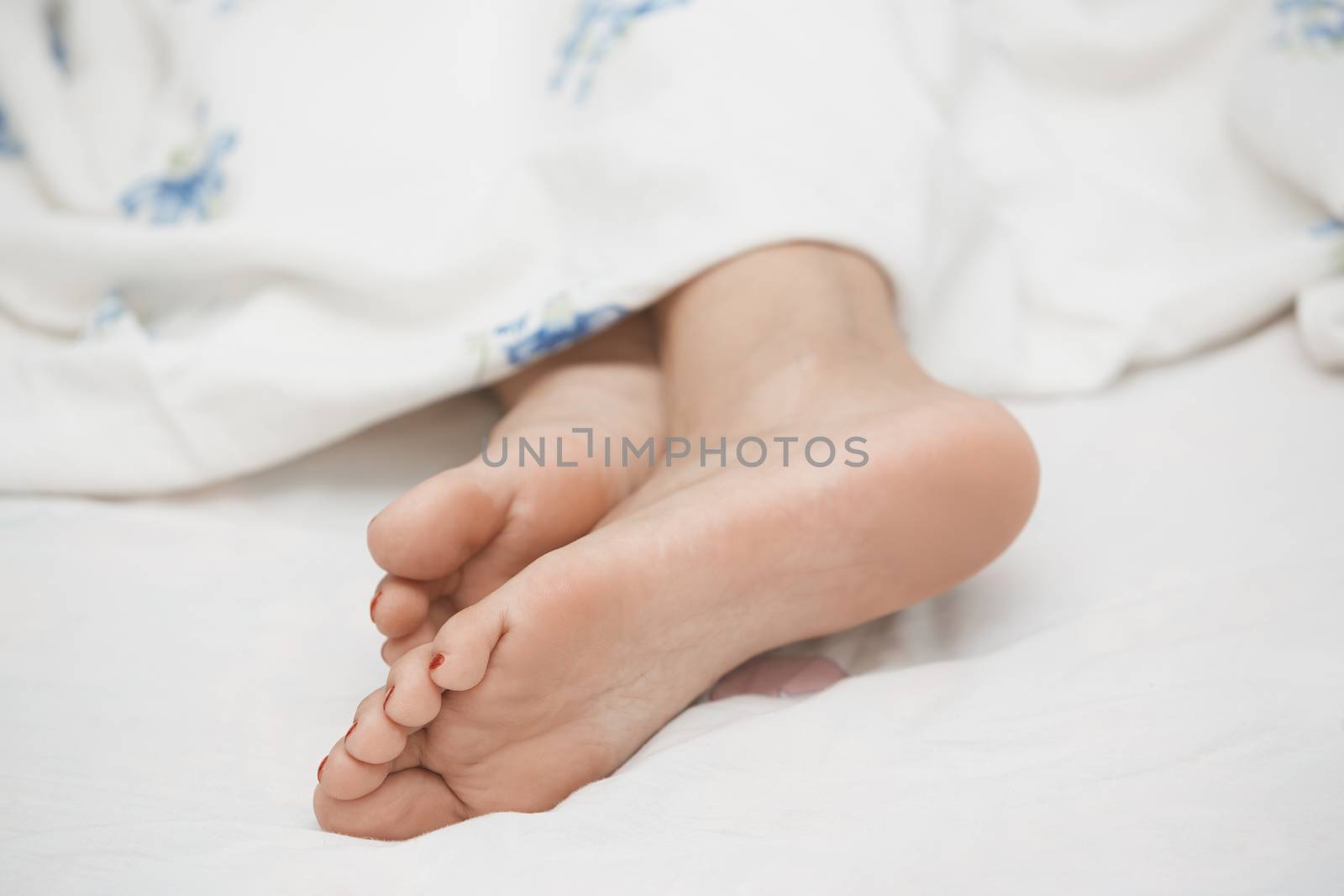 Feet of sleeping woman. Horizontal photo
