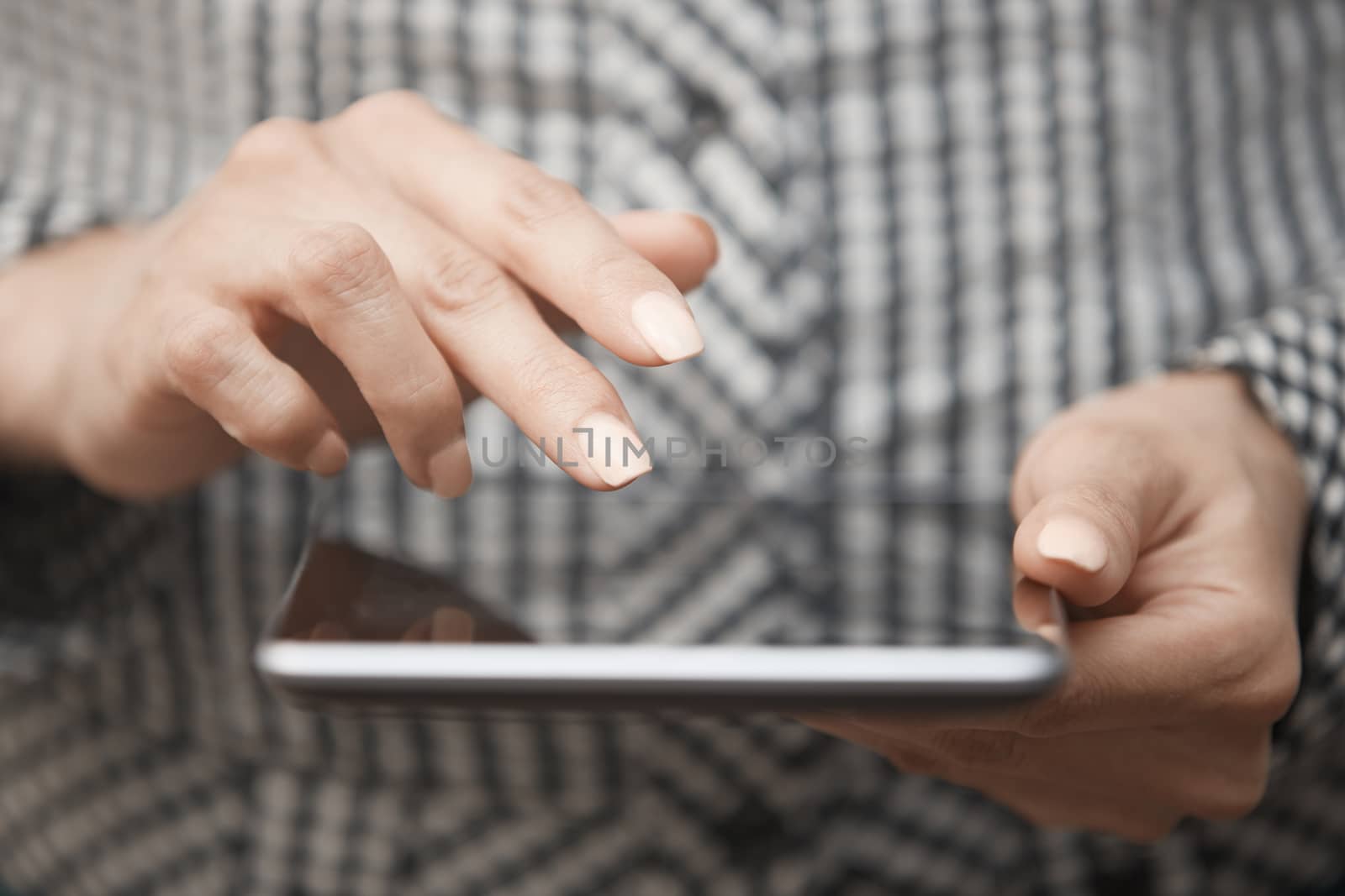Hands of woman using digital tablet