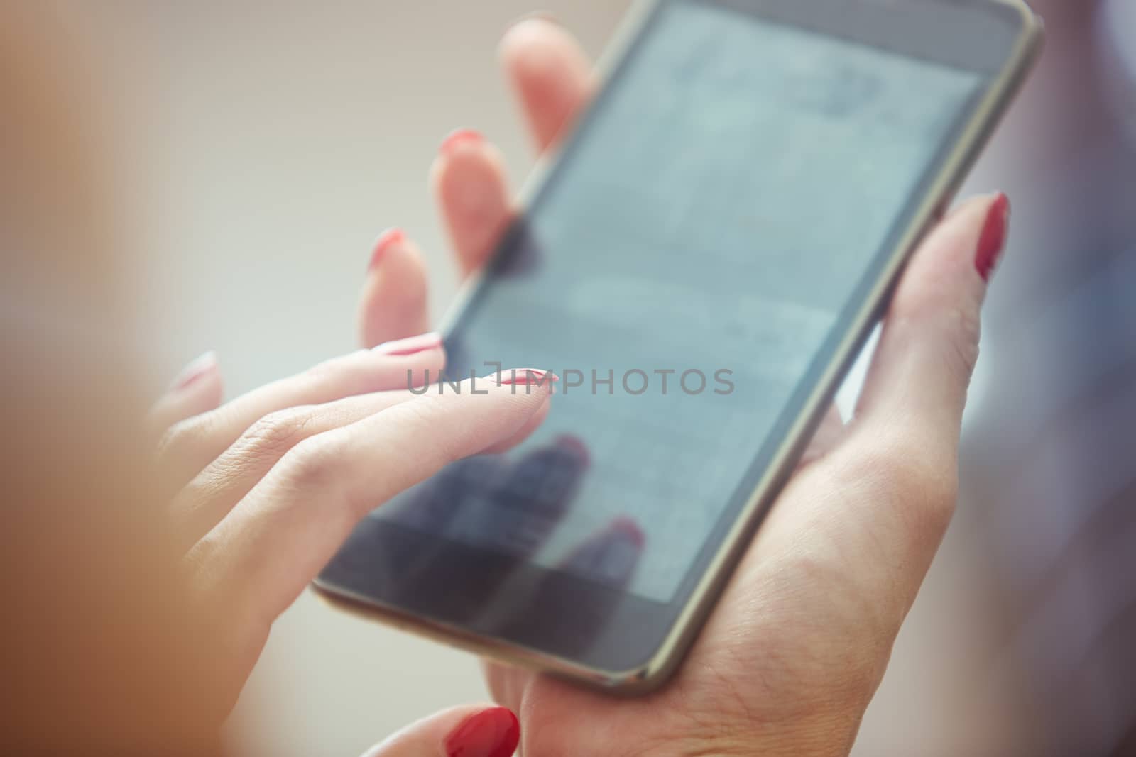 Hands of woman using smartphone