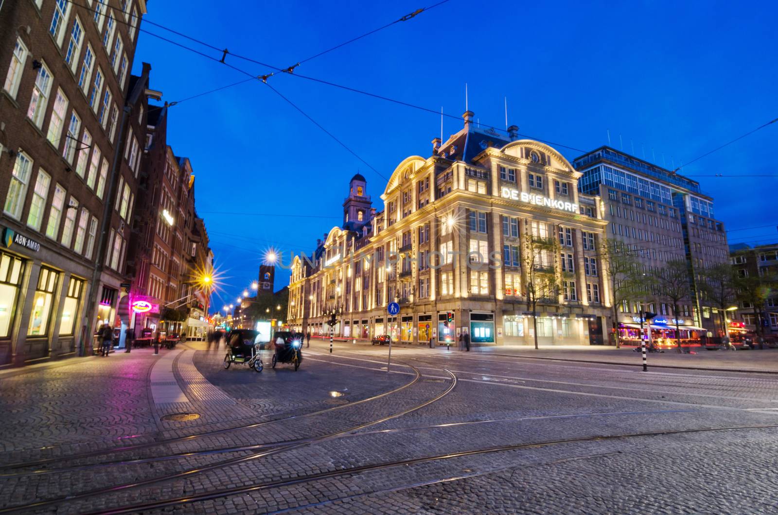 Amsterdam, Netherlands - May 7, 2015: Tourist visit De Bijenkorf store on Dam Square on May 7, 2015 in Amsterdam, Netherlands. De Bijenkorf is a chain of high-end department stores in the Netherlands.