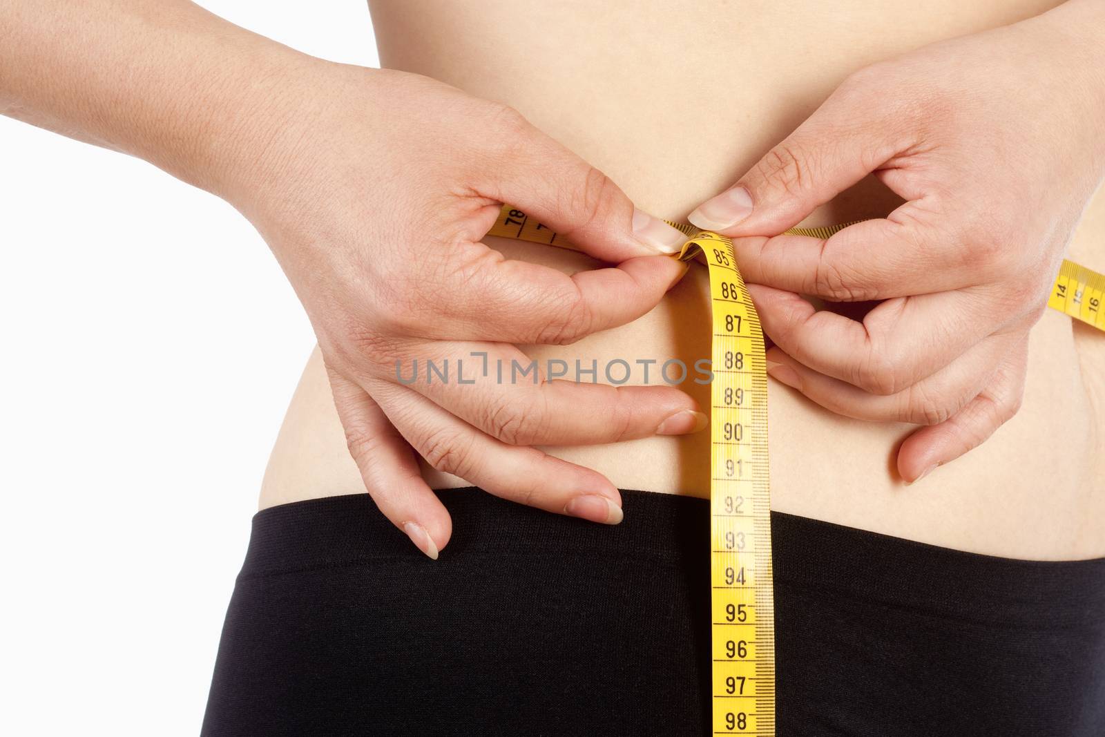 Woman in Black Underwear Measuring her Waist