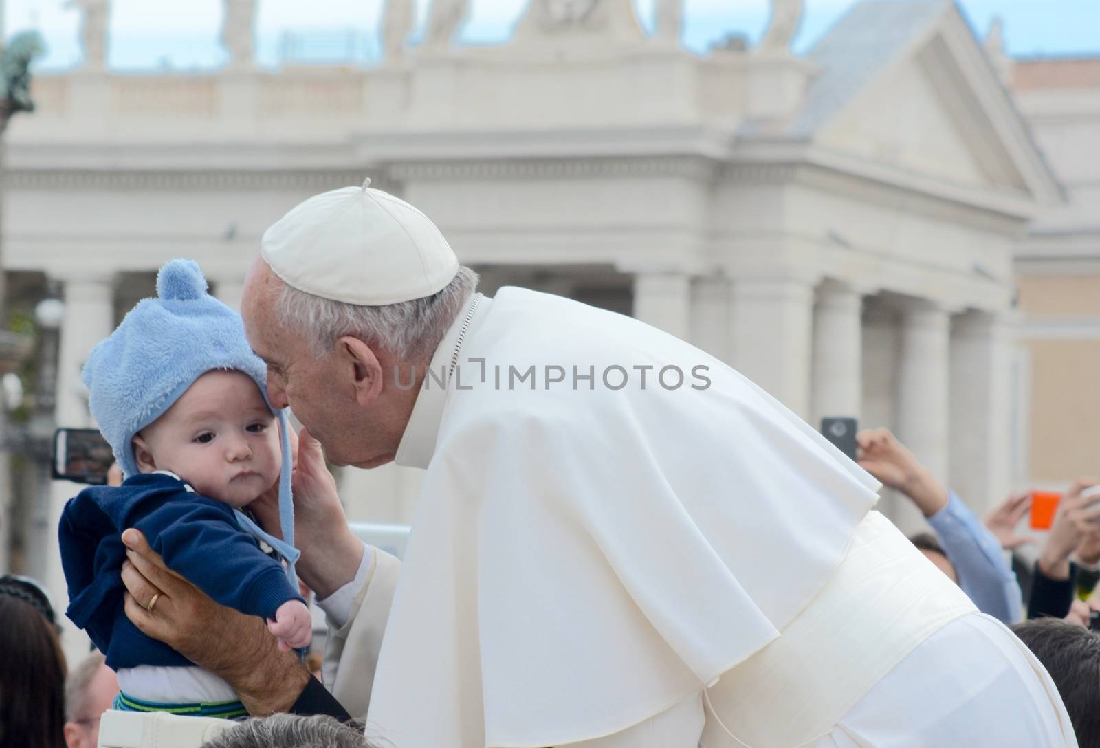 VATICAN CITY: Pope Francis kissed and held a young child, as he arrived at his general audience address in Saint Peter's Square, Vatican City on Sept. 30, 2015. Pope Francis reflected on his recent apostolic trip to Cuba and the United States. 