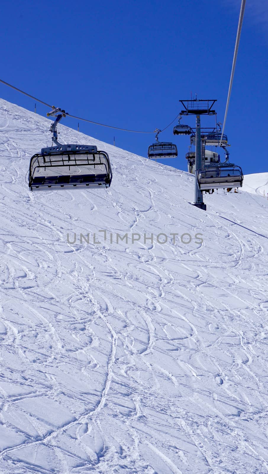 Empty ski cable car at snow mountains Titlis, Engelberg, Switzerland vertical view