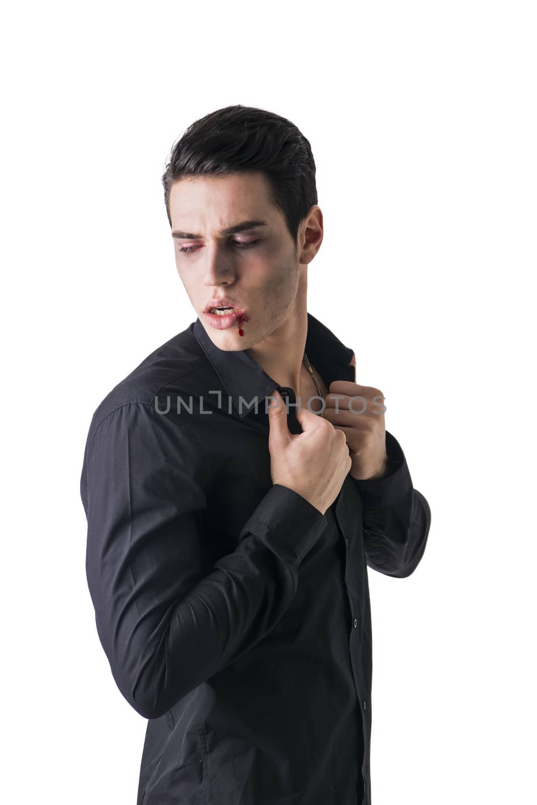Portrait of a Young Vampire Man with Black T-Shirt, Looking at the Camera, Isolated on White Background.