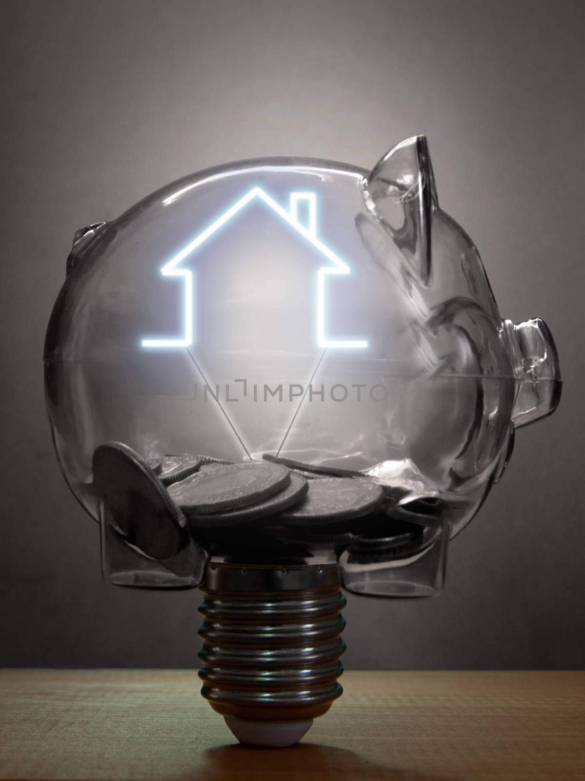 Piggybank light bulb with the glowing outline of a house inside 
