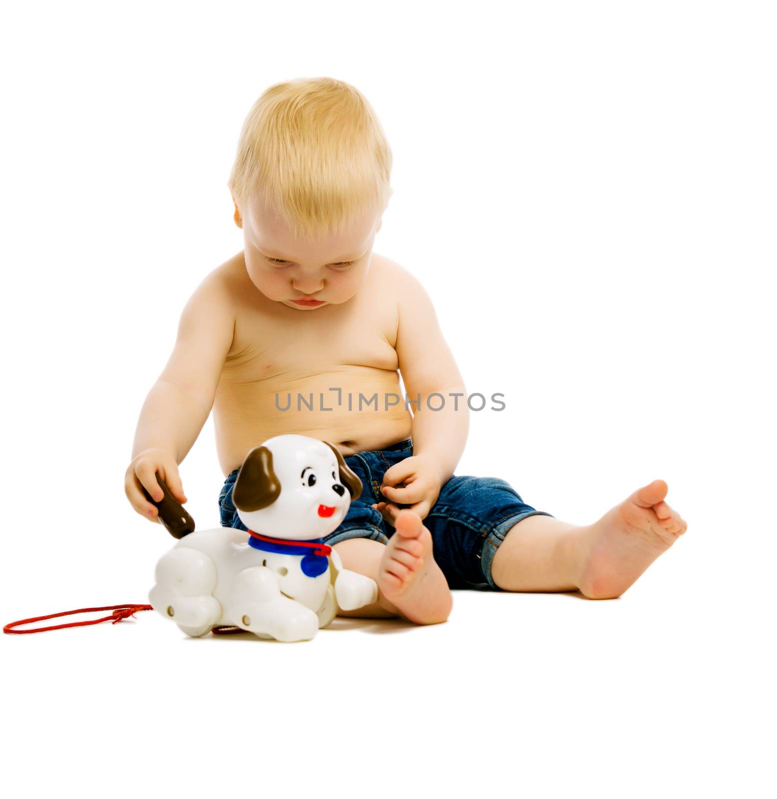 Baby boy playing with toys. Studio. isolated