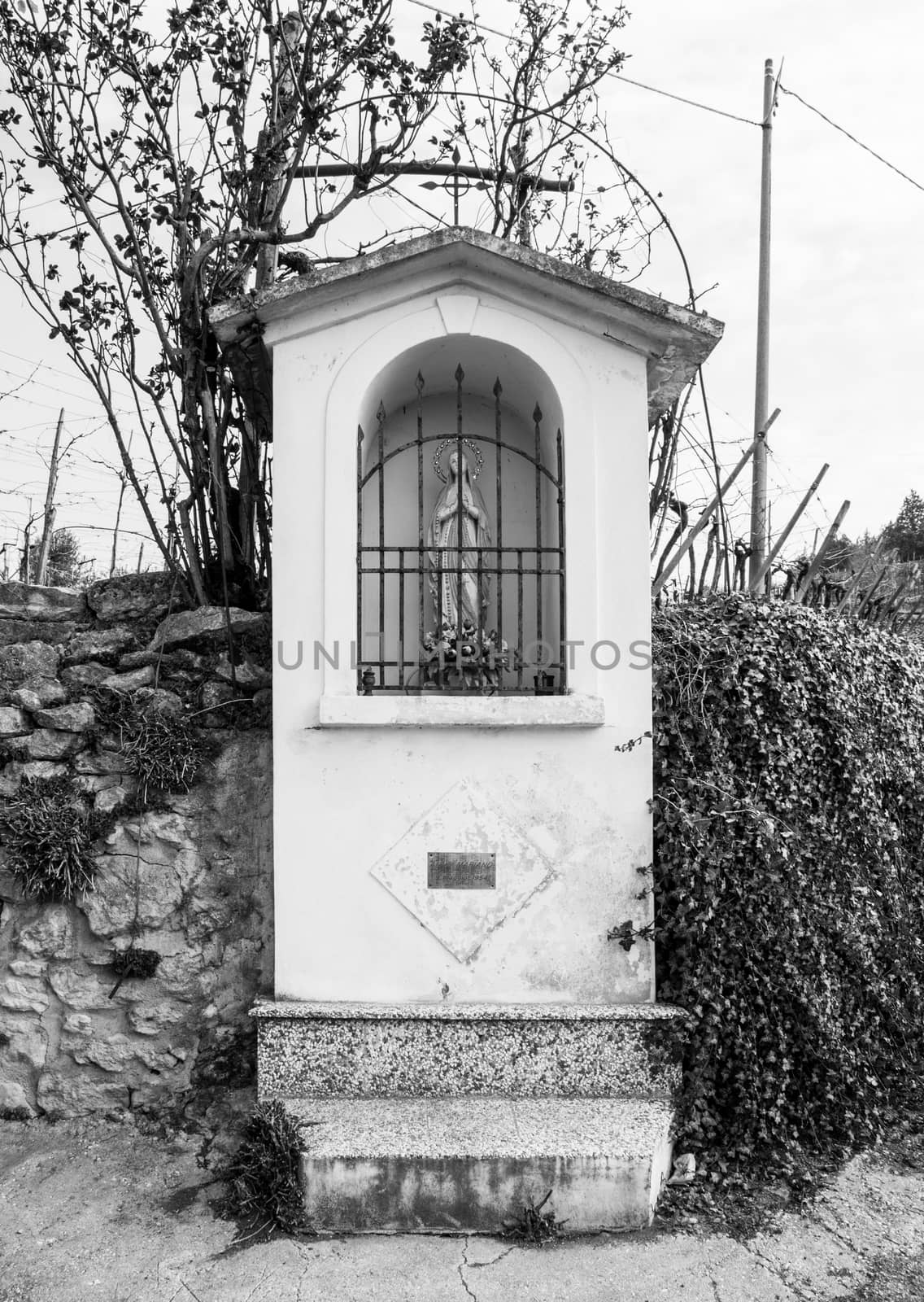 Italian traditional votive temple in the countryside dedicated to the Virgin Mary to propitiate the harvest