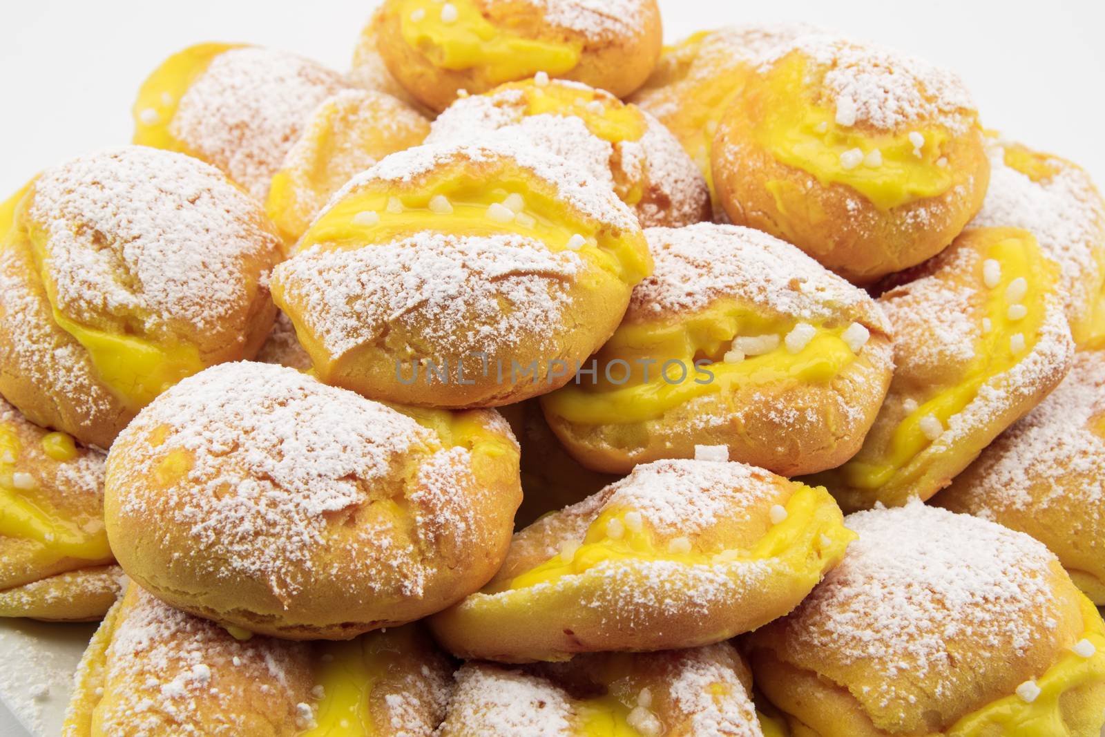 handmade cream puffs with icing sugar