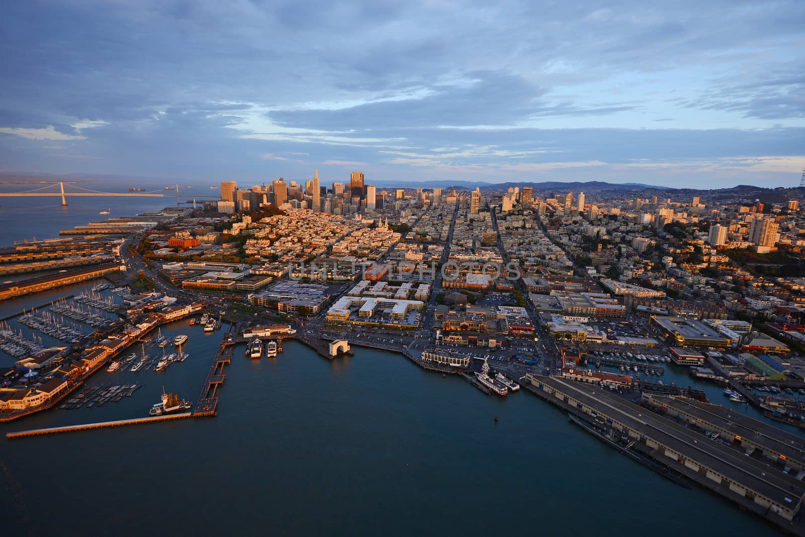 an aerial view of downtown san francisco with pier during sunset