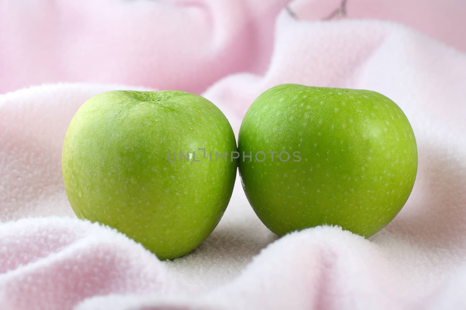 Green Apples on pink cloth