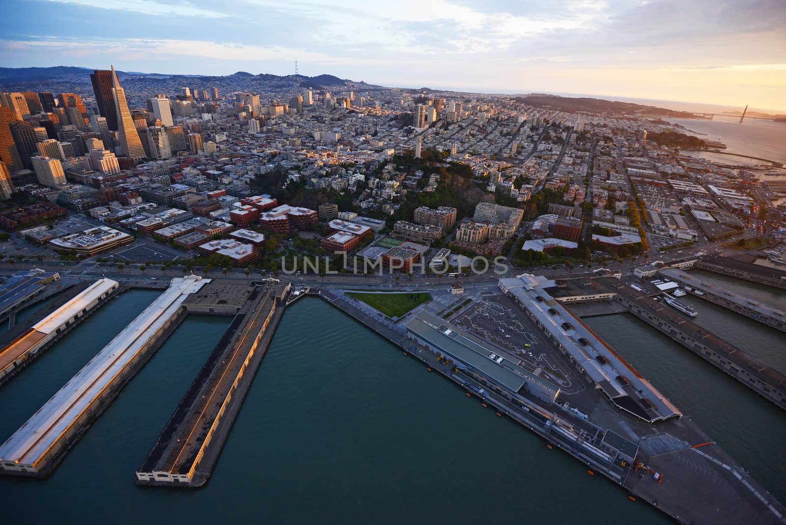 an aerial view of downtown san francisco with pier during sunset