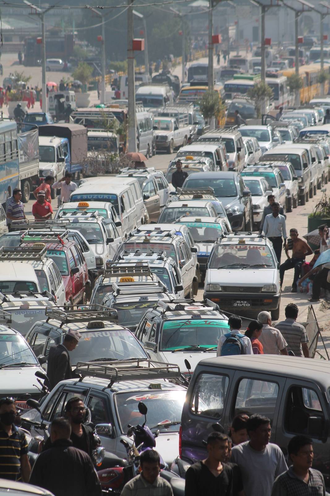 NEPAL, Kathmandu: Shortage of fuel and other supplies caused by the closure of border crossings between India and Nepal has prompted Nepalese residents to join long lines for petrol in Kathmandu, Nepal on September 30, 2015. Nepal has blamed a blockade by the Indian government for the closures, but India says the disruptions to trade are due to widespread unrest in Nepal following the enactment of its new constitution on September 20. The fuel crisis has forced the government to limit driving around Nepal, while some international airlines have cancelled flights to the country. 