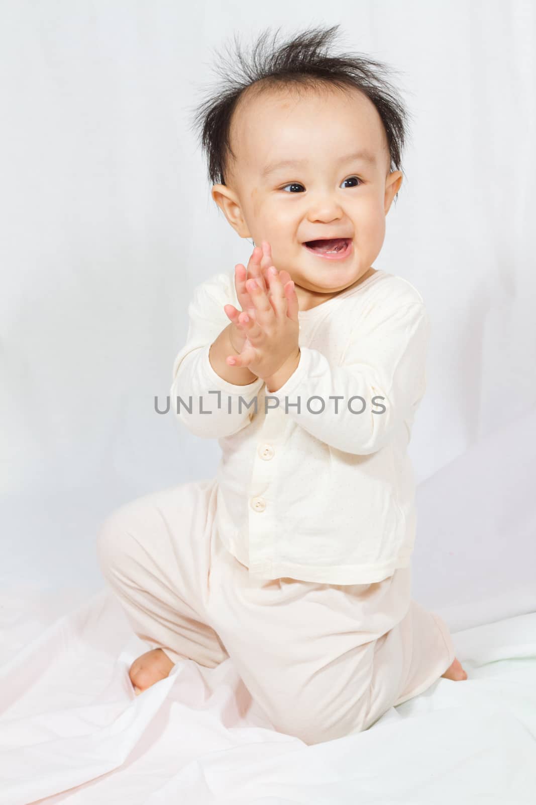 Asian Chinese baby smalling in white background